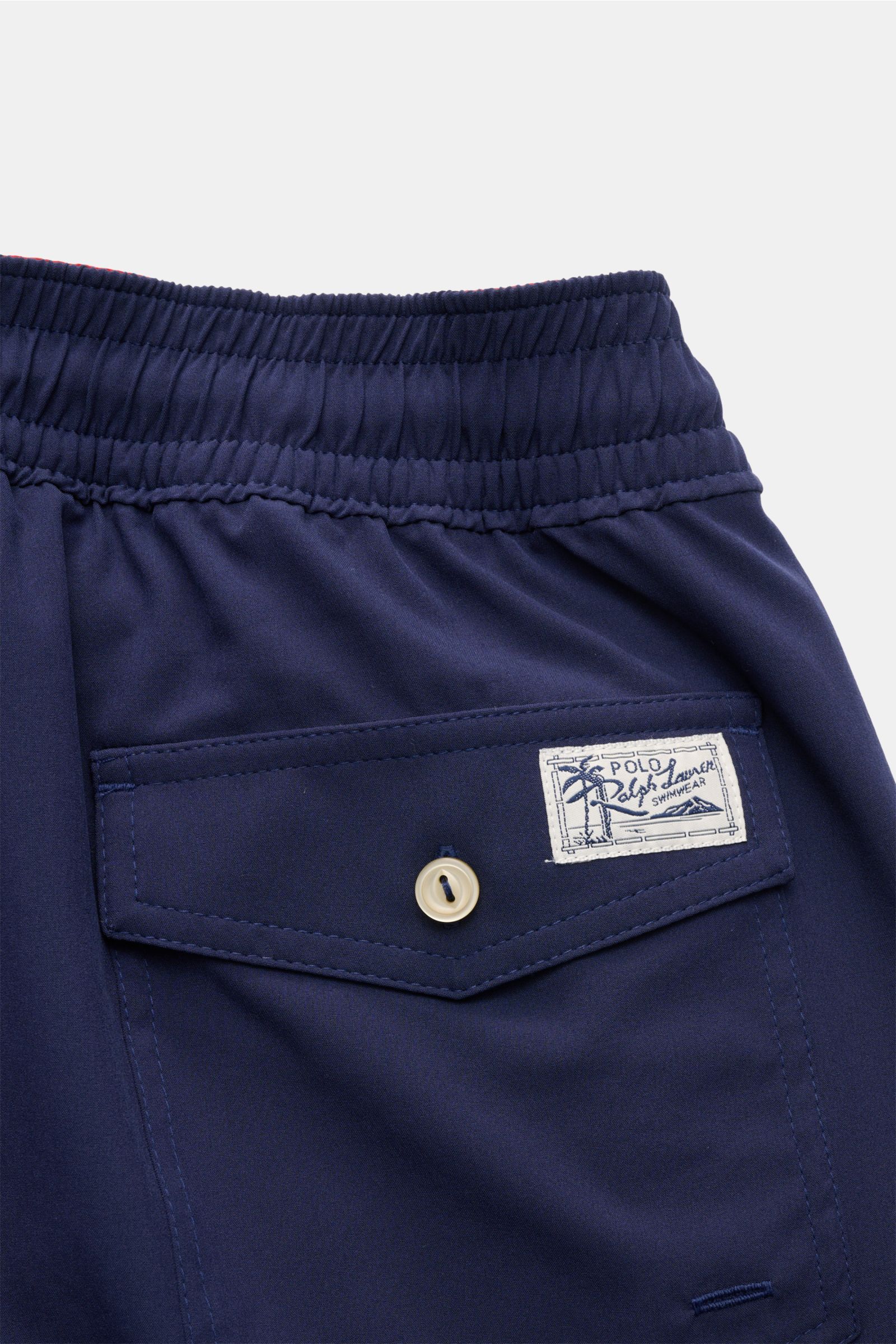 Close-up rear view of Polo Ralph Lauren Swim shorts 'Traveler' navy showing elastic waistband and back pocket with button flap and logo patch.

Stylish confidence for your travels: These POLO RALPH LAUREN swim shorts are the perfect companion for your 