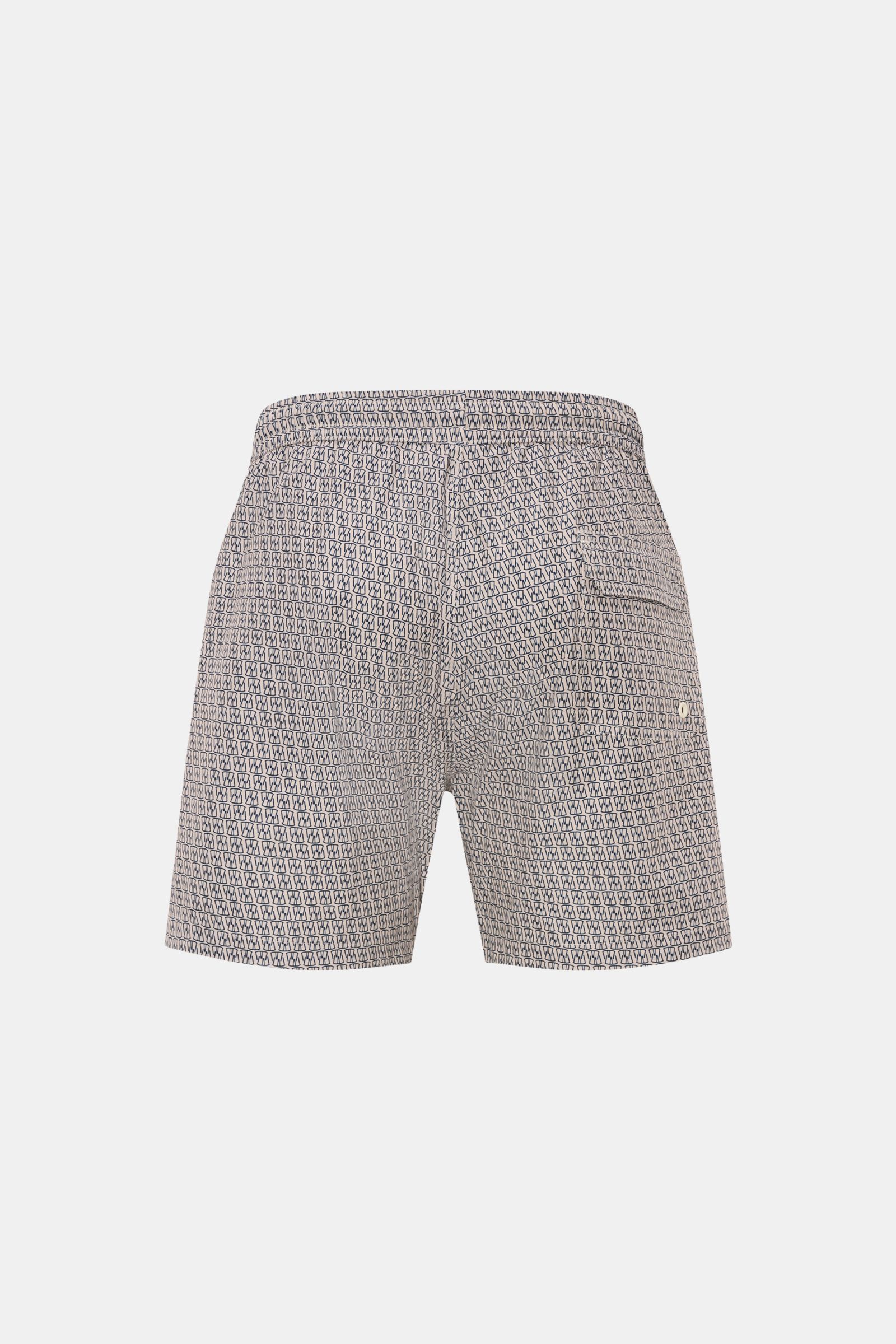 Rückansicht der 04651/ A trip in a bag Badeshorts 'Hansen' beige/navy gemustert mit elastischem Bund, seitlichen Taschen und Mesh-Innenfutter.