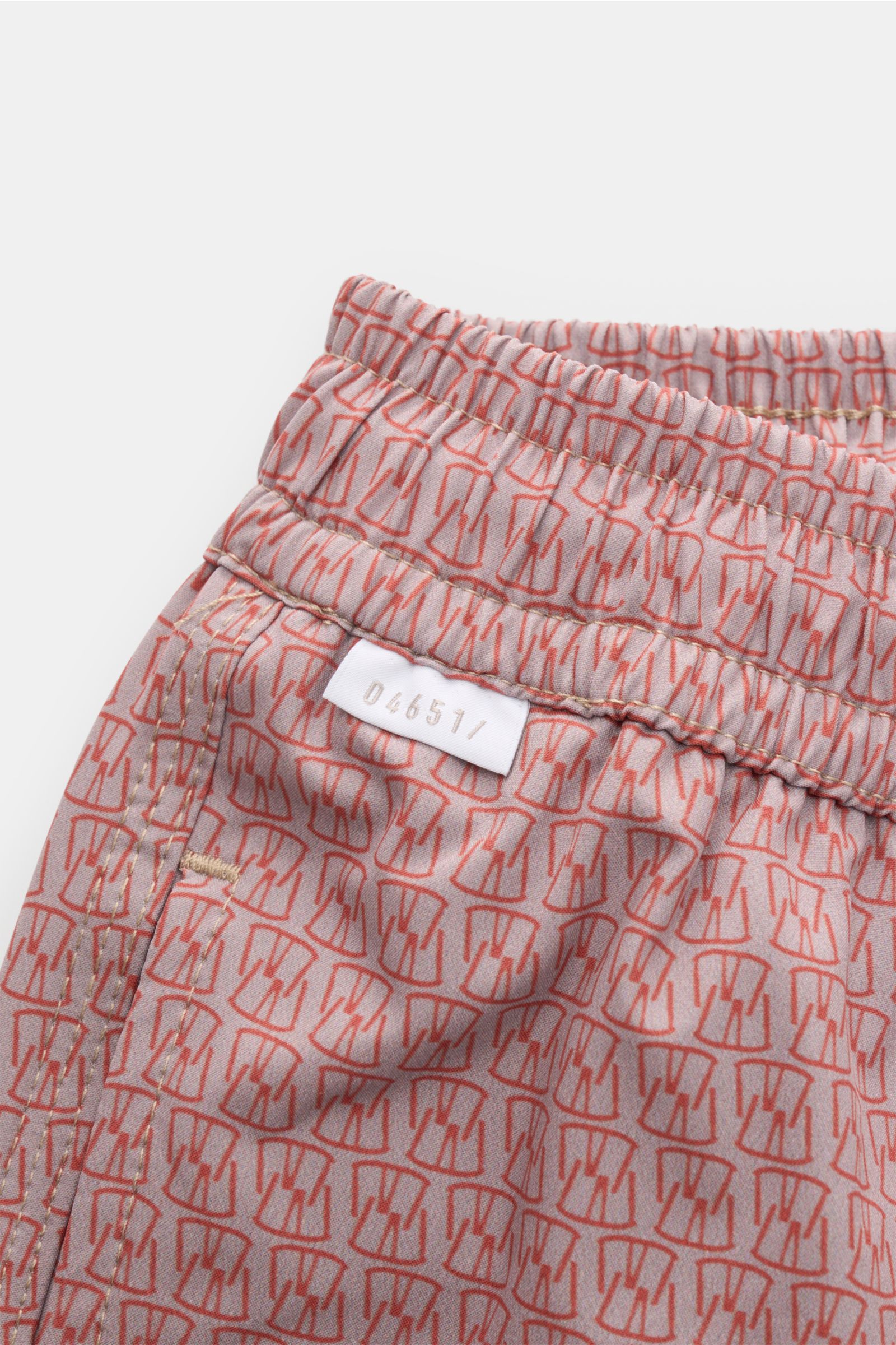 04651/ A trip in a bag Badeshorts 'Hansen' taupe/rot gemustert, Nahaufnahme seitlich mit elastischem Bund, Tunnelzug und Taschen.