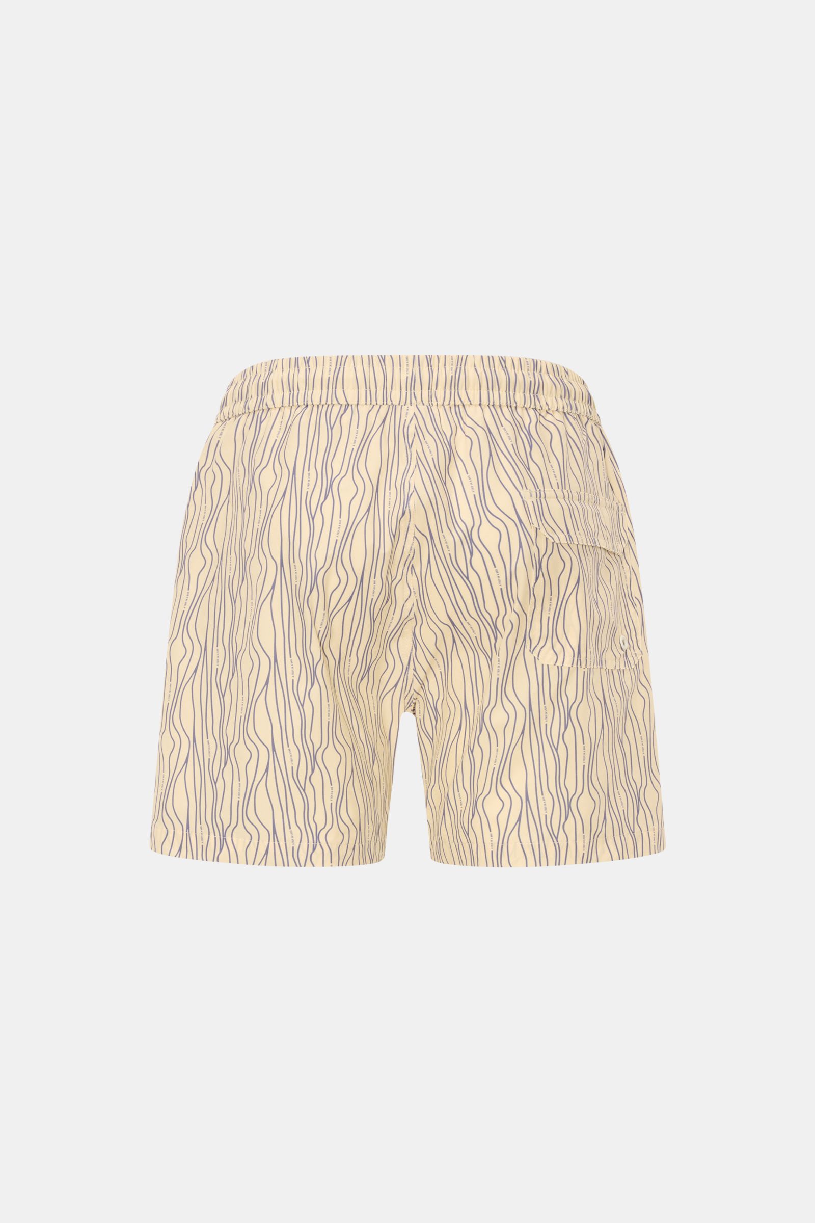 Rear view of 04651/ A trip in a bag Swim shorts 'Superkilen' pastel yellow/lavender patterned with wavy lines, elastic waistband, side and back pockets.

An eye-catching piece for summer: With their all-over print inspired by Copenhagen’s 'Superkilen' 