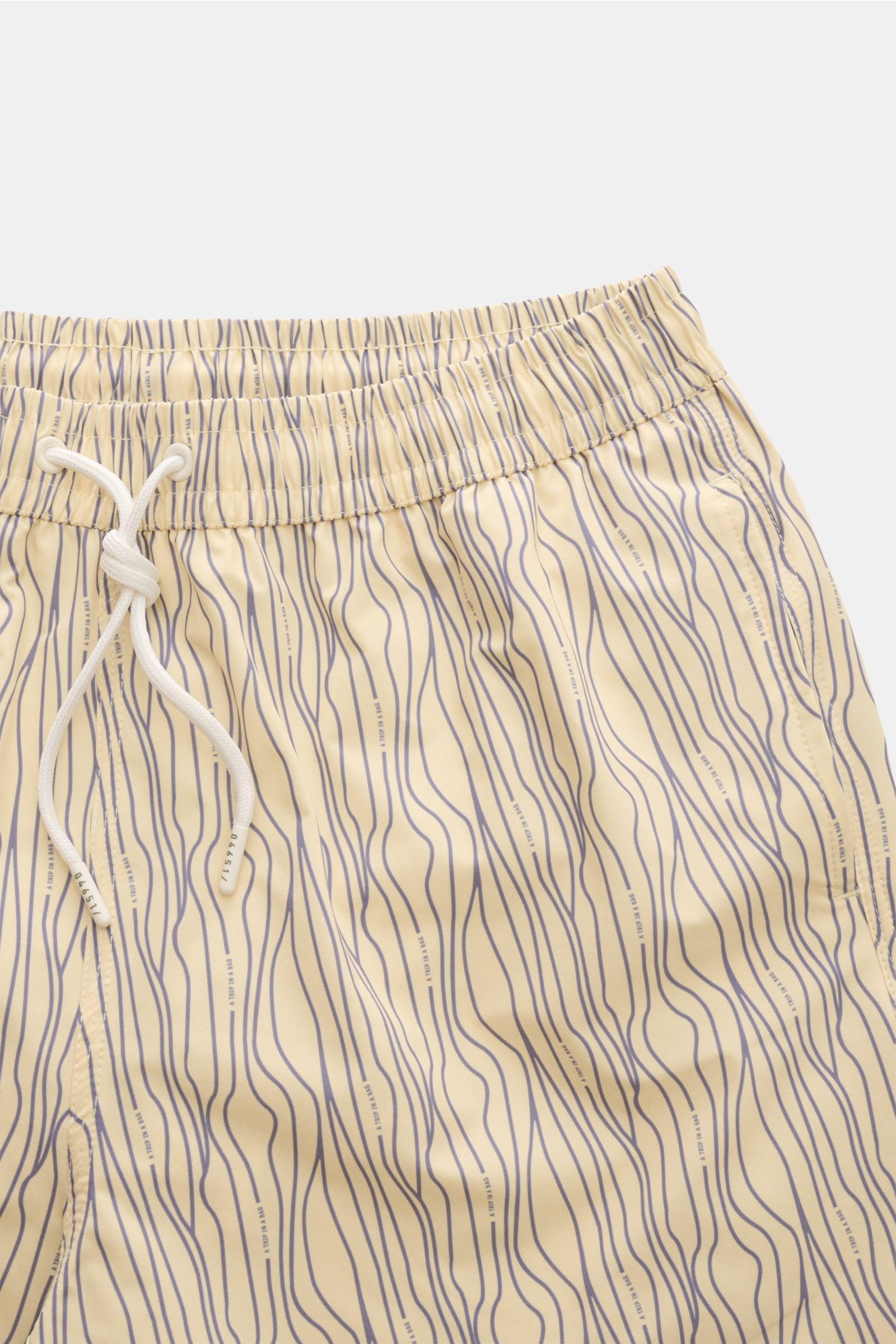 Close-up front view of 04651/ A trip in a bag Swim shorts 'Superkilen' pastel yellow/lavender patterned with elastic waistband and drawstring.

An eye-catching piece for summer: With their all-over print inspired by Copenhagen’s 'Superkilen' park, thes