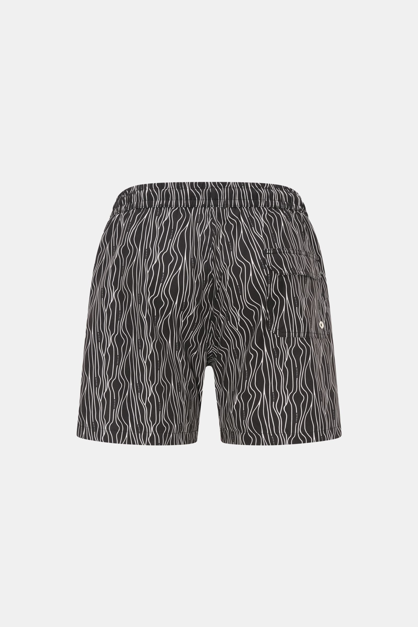 Rear view of 04651/ A trip in a bag Swim shorts 'Superkilen' black/white patterned with elastic waistband, side pockets, back pocket, and wavy print. 

An eye-catching piece for summer: With their all-over print inspired by Copenhagen’s 'Superkilen' pa
