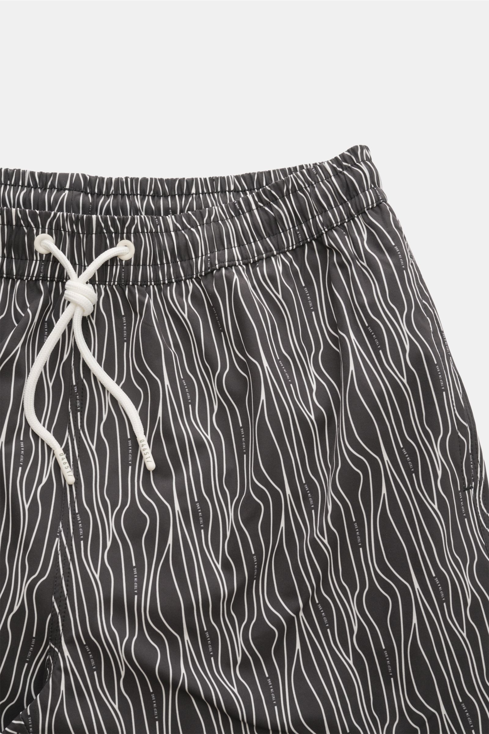 Close-up front view of 04651/ A trip in a bag Swim shorts 'Superkilen' black/white patterned with elasticated waistband and white drawstring.

Description: An eye-catching piece for summer: With their all-over print inspired by Copenhagen’s 'Superkilen