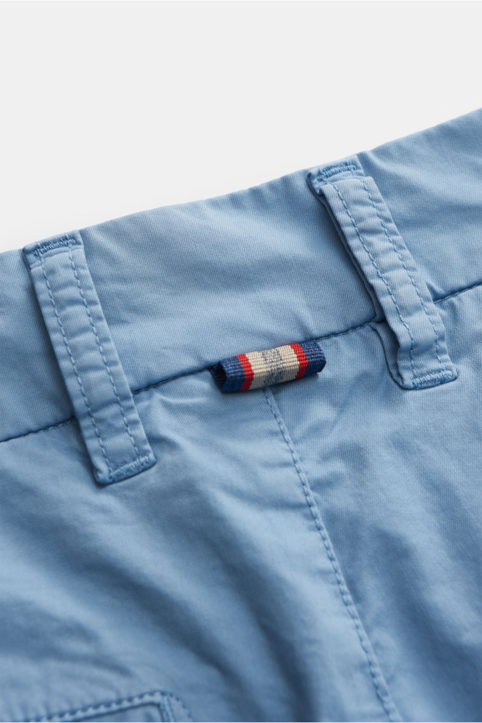 Close-up angled view of the waistband of Mason's Bermudas 'London' smoky blue, showing slightly elasticated cotton with soft feel, regular fit, zip and waist button, French pockets, small watch pocket, jetted back pockets with snap button, and small MASON