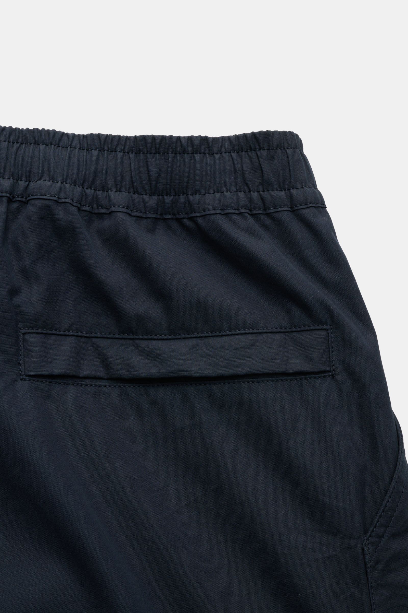 Close-up rear view of Stone Island Shorts 'Ghost' navy showing elasticated waistband and jetted back pocket in pure cotton.

Modern utility design: These STONE ISLAND shorts from the 'Ghost' Capsule Collection are timelessly understated in high-quality