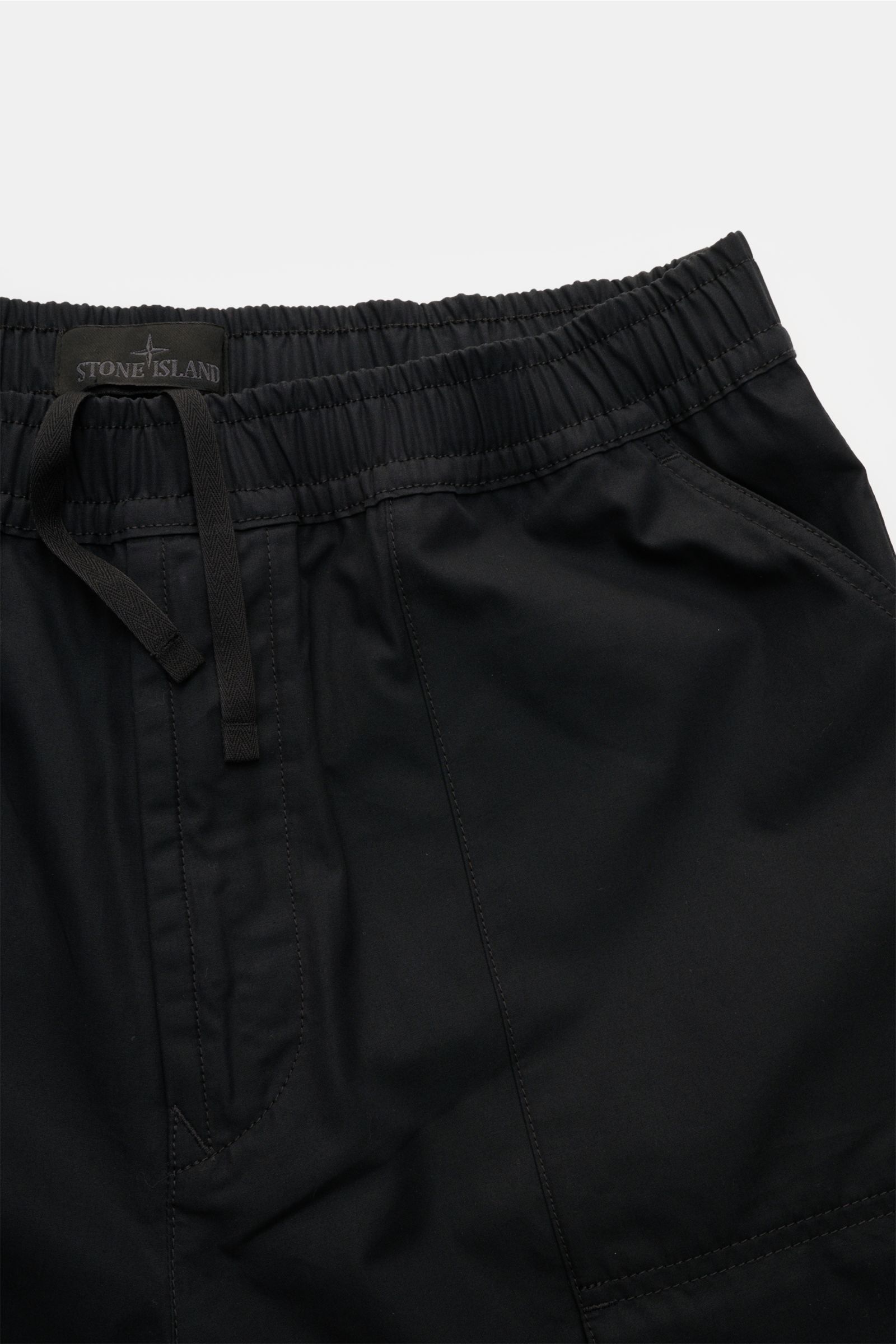 Close-up front view of Stone Island Shorts 'Ghost' black showing elasticated waistband, drawstring, and pocket details in pure cotton.

Modern utility design: These STONE ISLAND shorts from the 'Ghost' Capsule Collection are timelessly understated in h