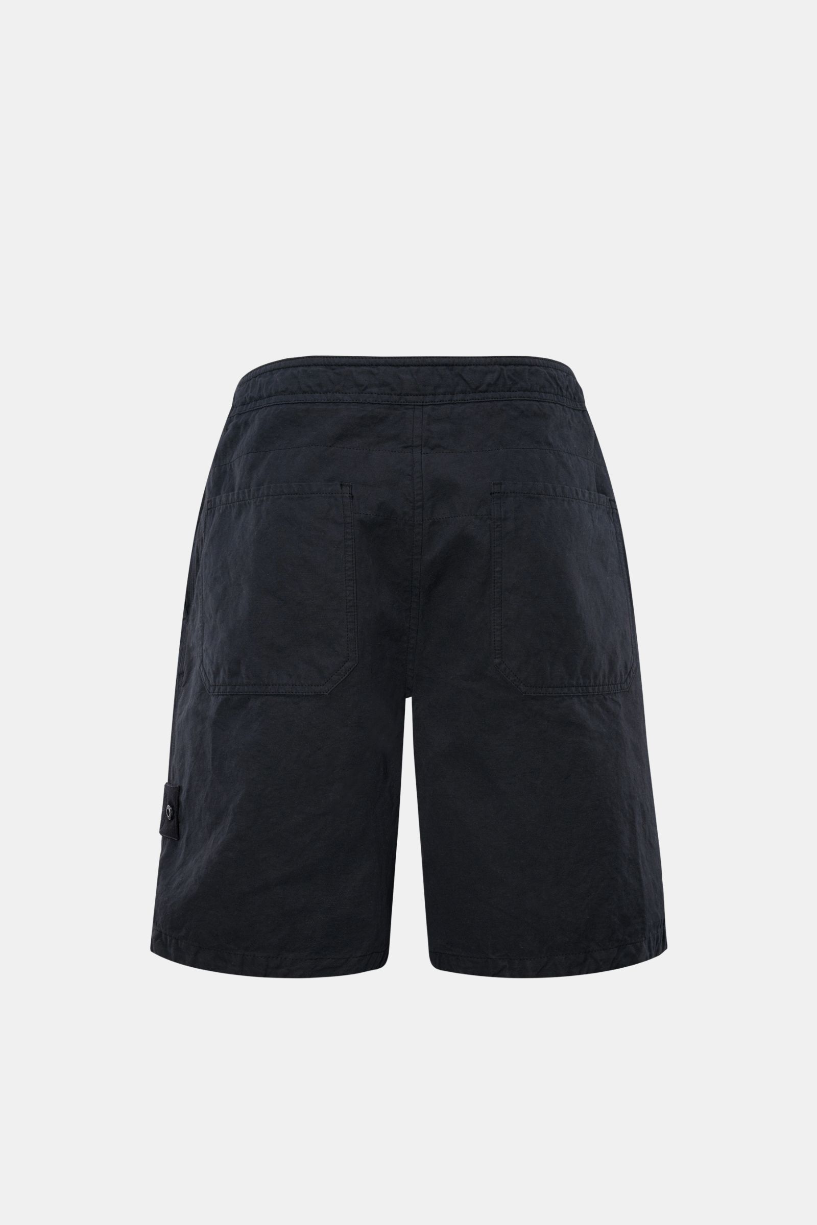 Stone Island Shorts 'Ghost Piece' navy shown from the back, made of robust cotton-linen canvas with garment dyed fabric, featuring regular fit, zipper and button closure, French pockets, tonal compass badge, and patch back pockets, ideal for summer wear. 