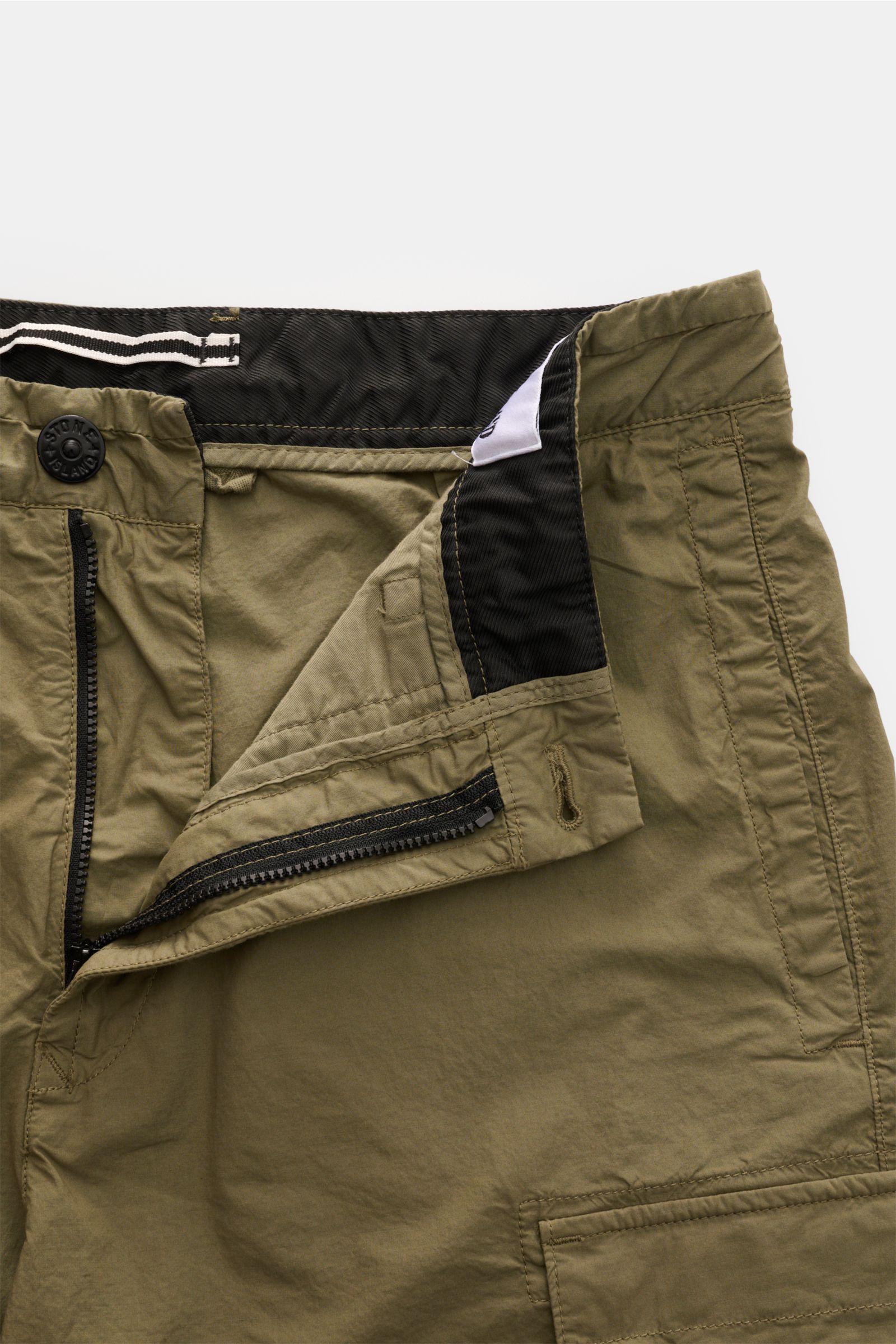 Stone Island Cargo-Shorts oliv in Nahaufnahme von oben, geöffnet mit Reißverschluss, Bundknopf, Cargotaschen und Kompass-Badge.