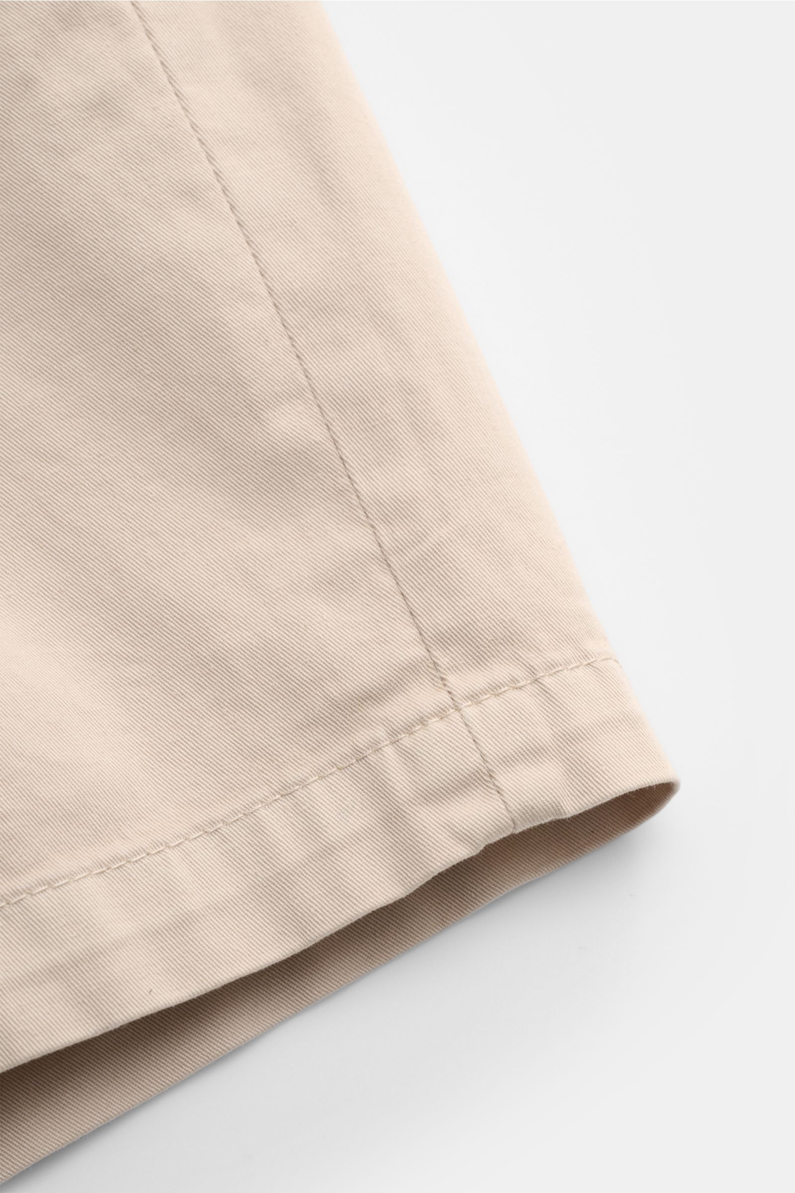 Nahaufnahme der beige Dondup Shorts 'Manheim' aus elastischer Baumwolle mit weichem Griff, sichtbarem Saum und feiner Twill-Struktur.