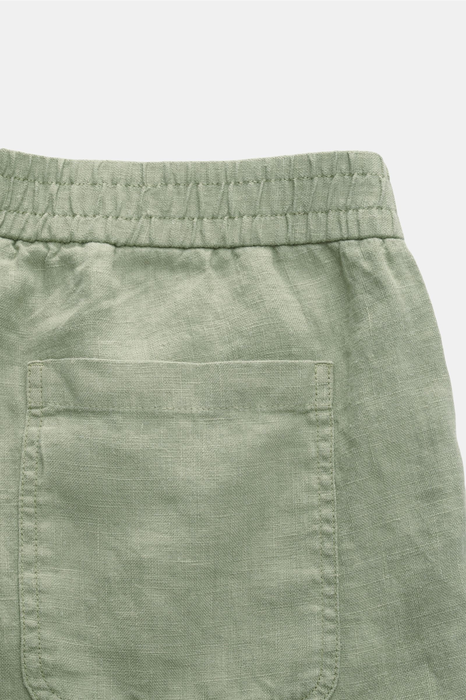 Back close-up of 04651/ A trip in a bag Linen shorts sage showing elastic waistband, patch back pocket, and soft airy linen fabric.

With this airy model, 04651/ A TRIP IN A BAG presents a comfortable pair of pure linen shorts that are the perfect comp