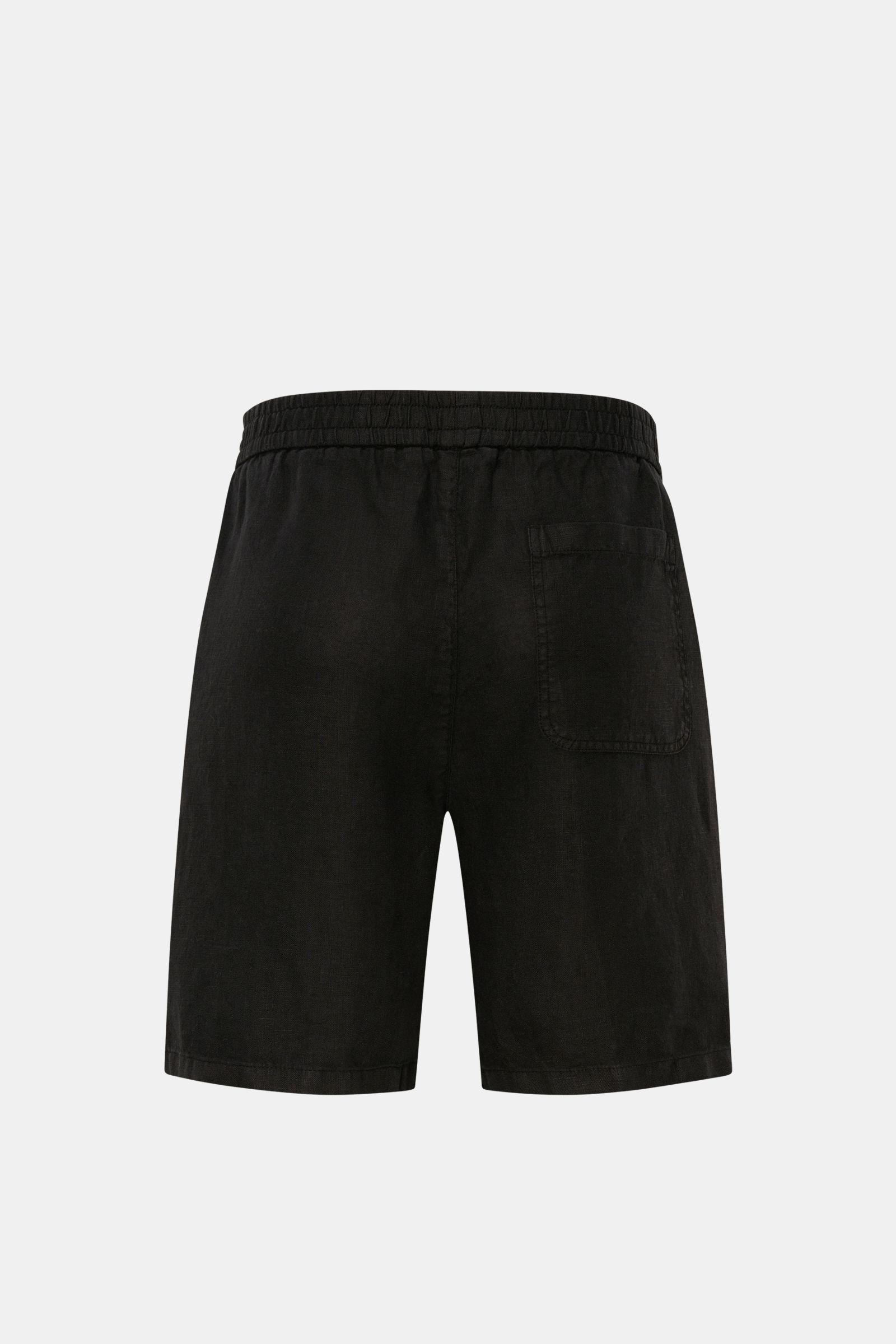 Back view of 04651/ A trip in a bag Linen shorts black showing elastic waistband, patch back pocket, and garment-dyed black linen fabric.

Description: With this airy model, 04651/ A TRIP IN A BAG presents a comfortable pair of pure linen shorts that a