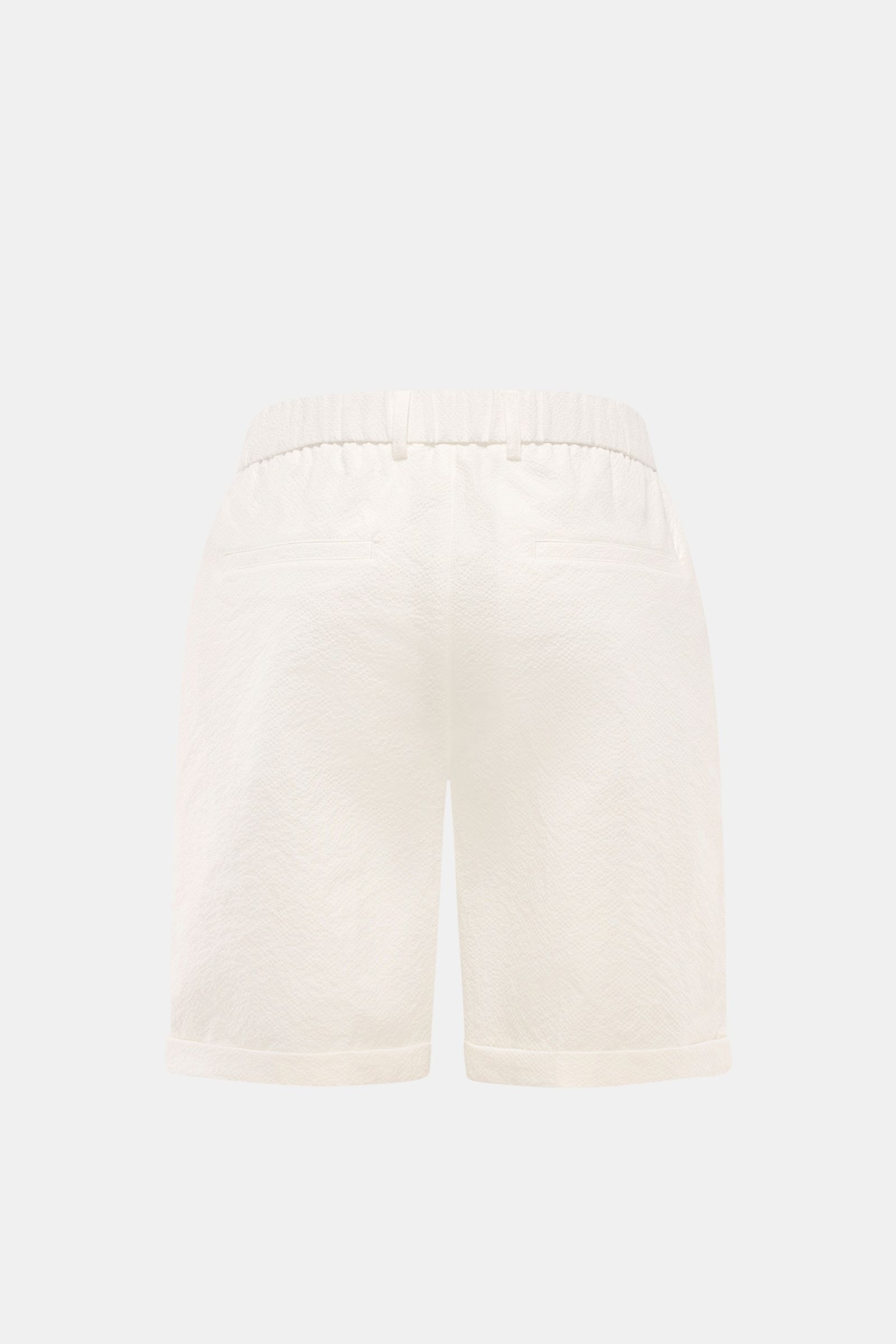 Rear view of 04651/ A trip in a bag Seersucker shorts white, made of textured microfibre with elasticated waistband, French and hip pockets, double pleat, and fixed hem turn-up.  

With this classic model, 04651/ A TRIP IN A BAG presents a comfortable 