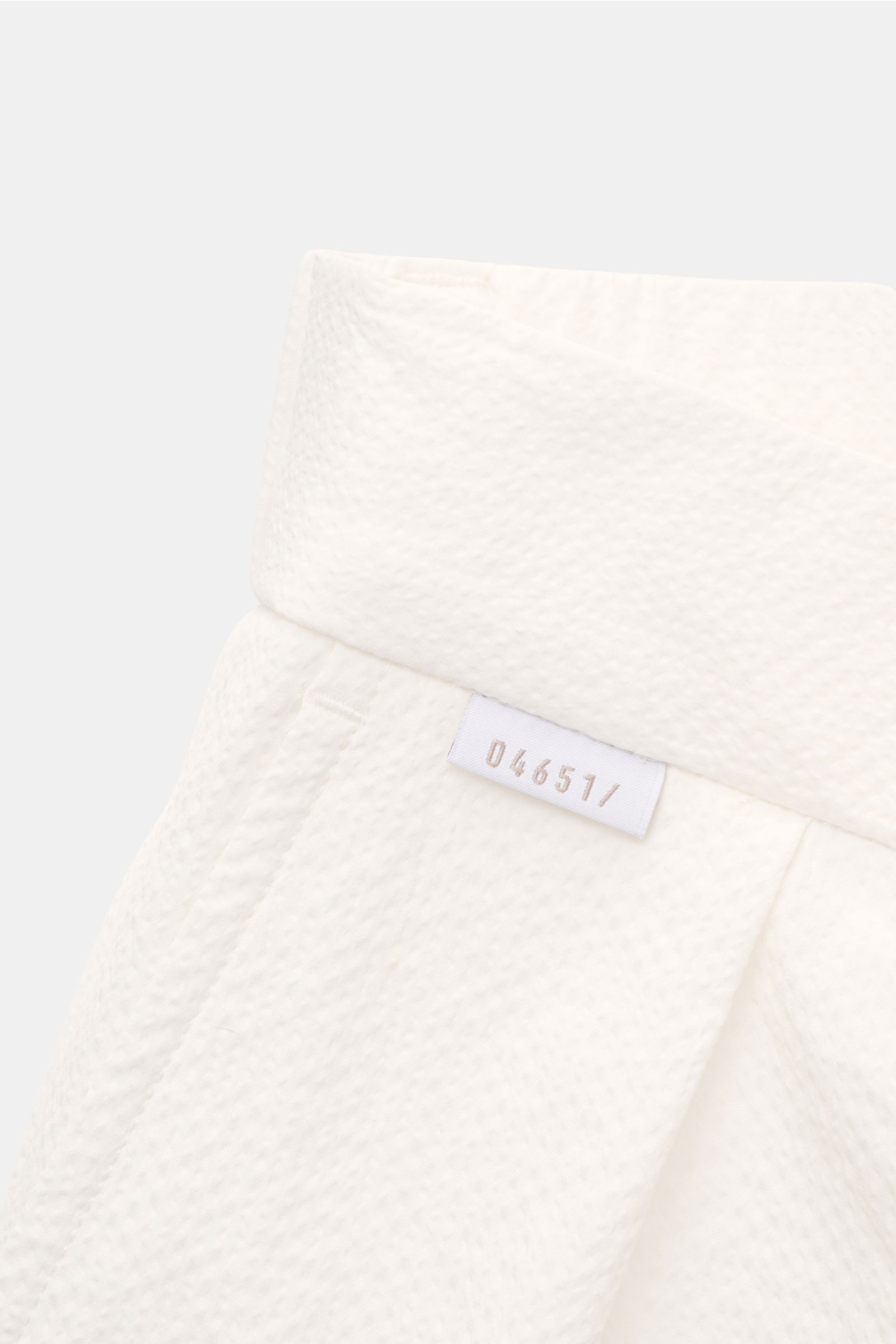 Close-up front view of 04651/ A trip in a bag Seersucker shorts white, showing textured seersucker microfibre fabric, waistband with woven label.

With this classic model, 04651/ A TRIP IN A BAG presents a comfortable pair of shorts in typically textured 