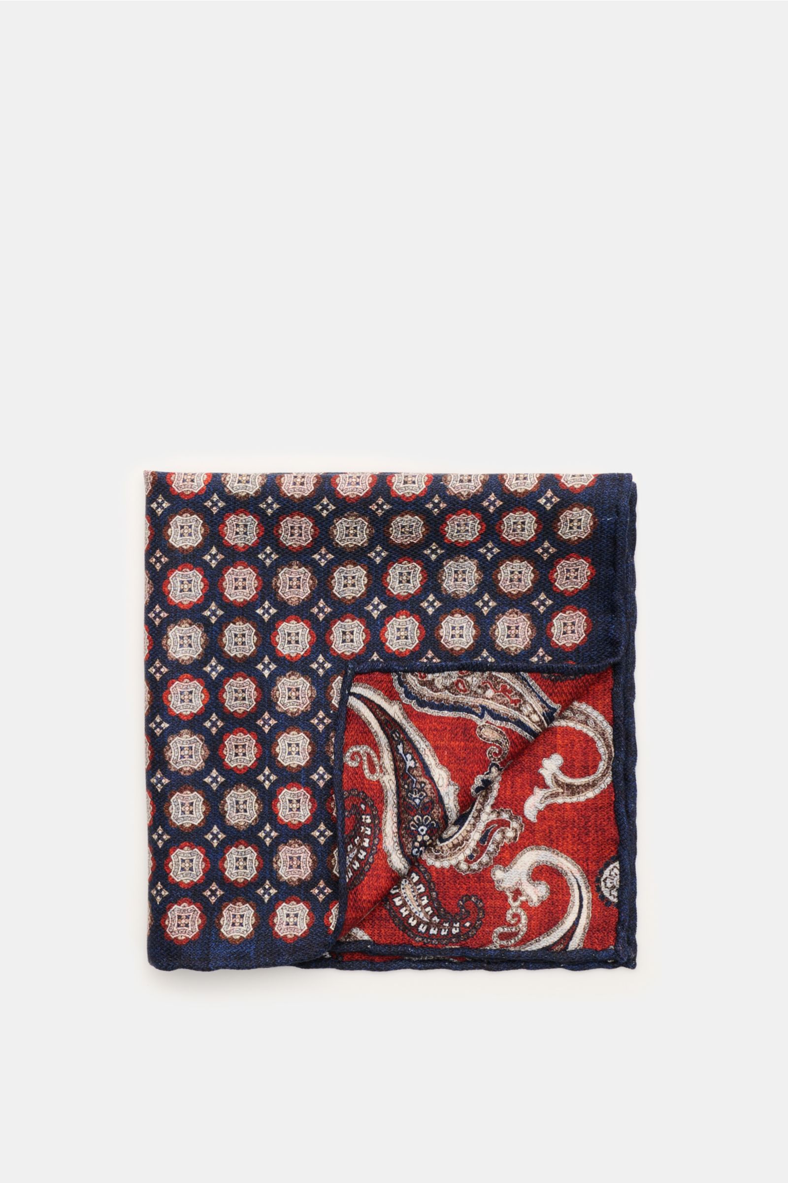 Rosi Collection Silk pocket square 'Easy' navy/dark brown/rust brown patterned, folded with corner flipped, showing elegant medallion print, paisley back, pure silk, soft smooth touch, hand-rolled edges, made in Italy, approx. 30.5 x 30.5 cm, top-down vie