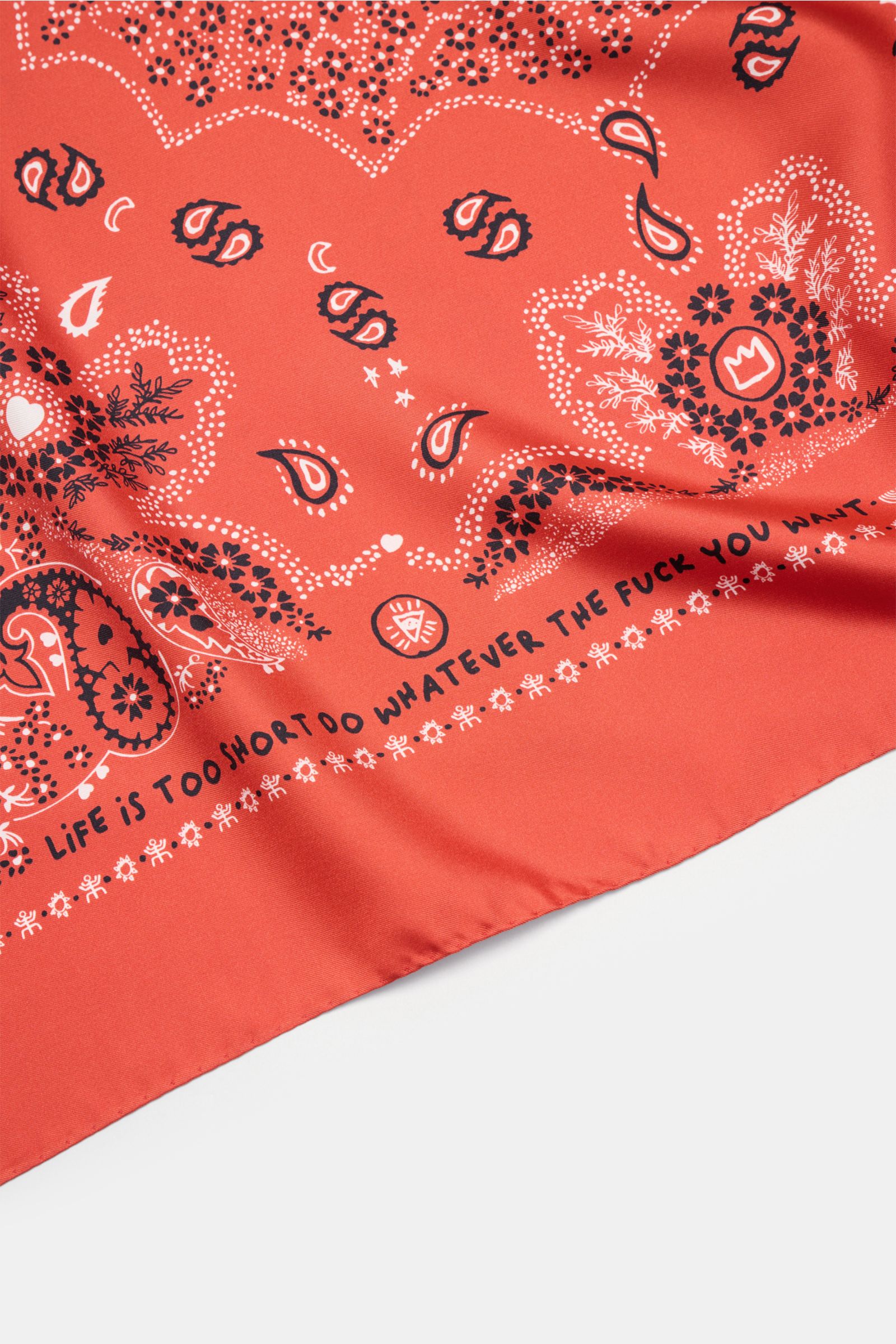 Ace Denim Silk scarf red/black/white patterned shown from a close-up angled top view, featuring paisley design on pure silk with soft feel. Eye-catching for the warm season: The ACE DENIM silk scarf in a bandana design is a casual statement accessory for 