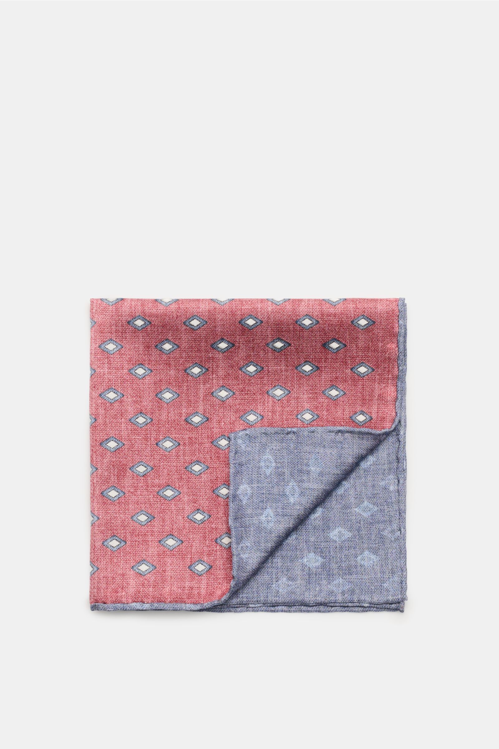 Brunello Cucinelli Seiden-Einstecktuch rot/rauchblau/hellgrau gemustert, photographed from above, shows a folded silk pocket square with an elegant diamond pattern, smooth texture, contrasting reverse side, and finely rolled edges in contrast color. El