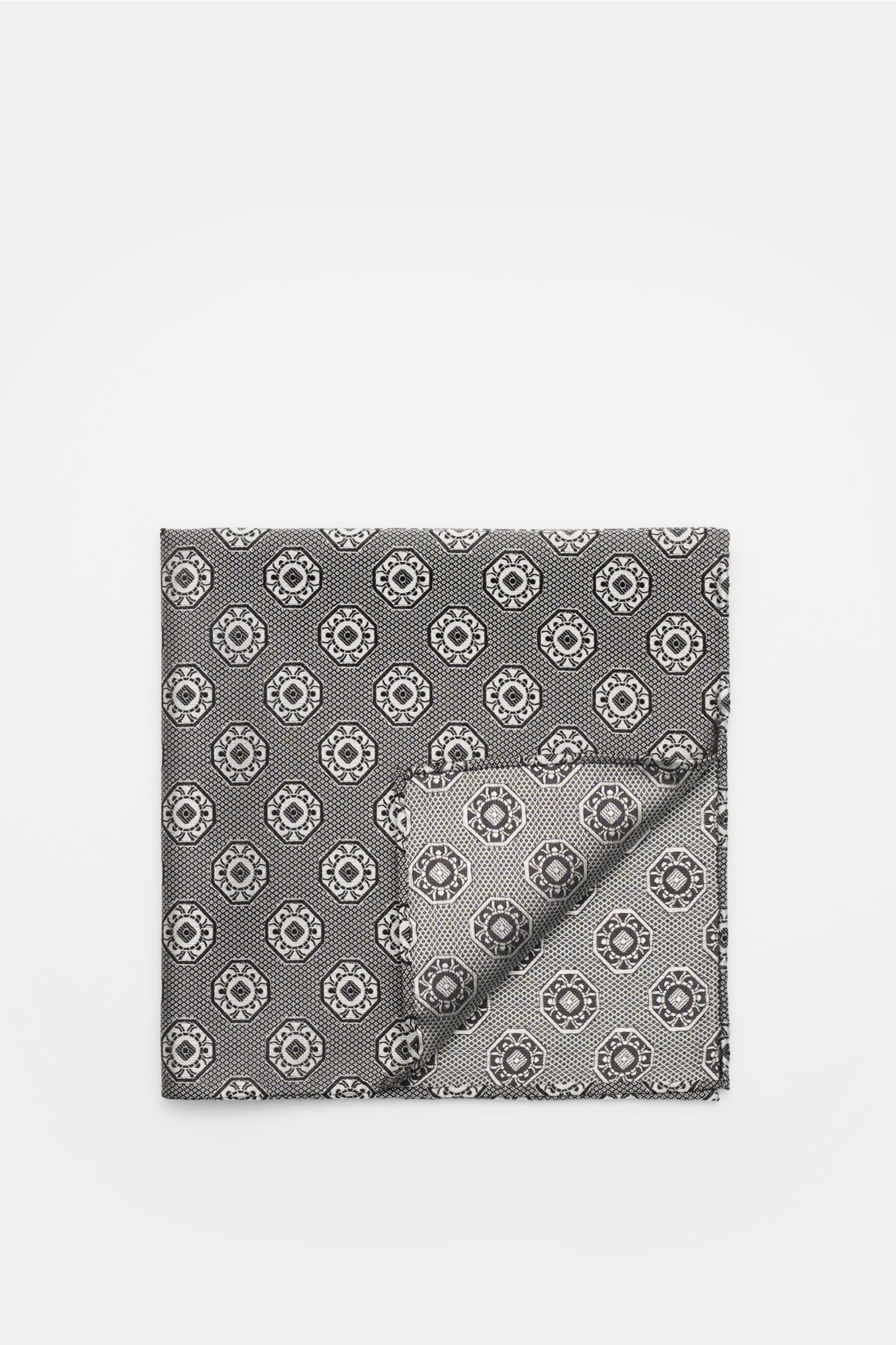 Top-down view of a folded Brunello Cucinelli Silk pocket square grey/black patterned with a fine medallion weave and rolled edges.

Elegant accent: This silk pocket square by BRUNELLO CUCINELLI has a fine medallion weave pattern that creates a subtle h