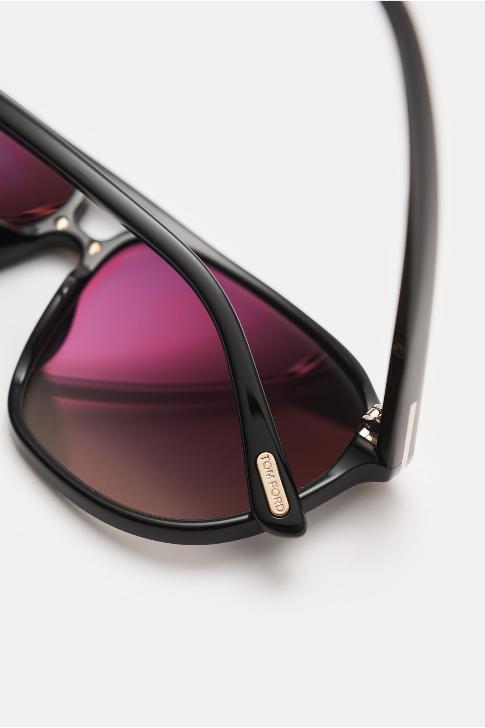Close-up angled view of Tom Ford Sunglasses 'Bruce' black with sleek black acetate frame and purple tinted lenses, showing logo on temple.

Cool style meets UV protection: With large polarised lenses and distinctive frames, the 'Pierre' sunglasses from