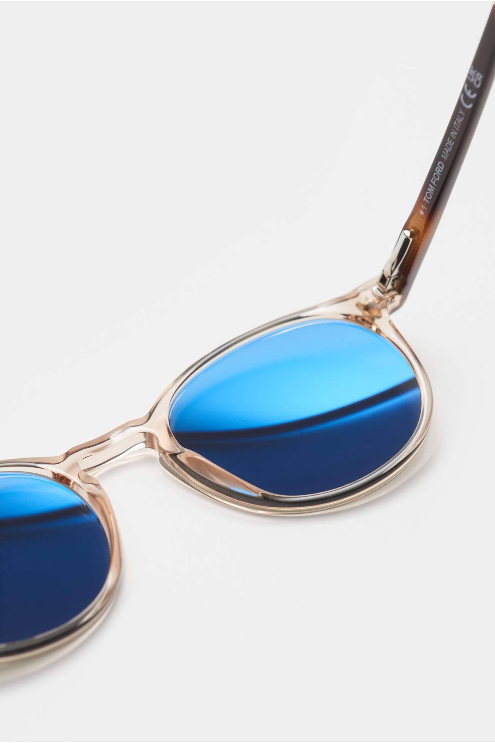 Close-up side view of Tom Ford Sonnenbrille 'Andrea' beige/braun gemustert/grün with round transparent acetate frame, blue plastic lenses, and tortoiseshell-patterned temples.