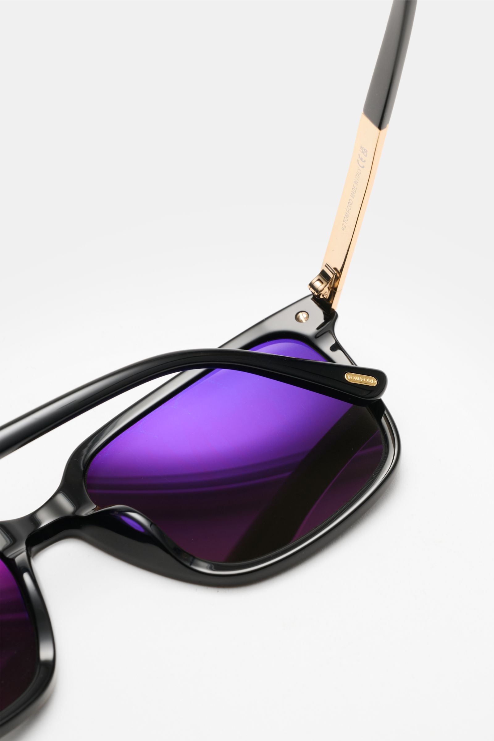 Close-up top-side angle of Tom Ford Sunglasses 'Jochem' black with slightly square shape, purple tinted plastic lenses, and acetate frame.

Stylish all-rounder: With their timeless design, these sunglasses by TOM FORD are an ideal summer essential.