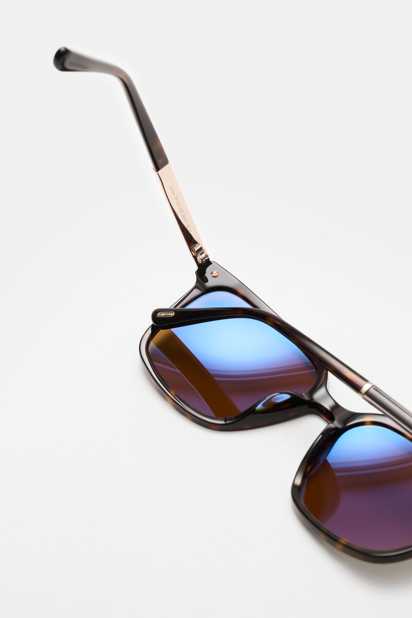 Tom Ford Sunglasses 'Jochem' dark brown mottled shown from a close-up top angle, featuring slightly square shape, evenly tinted plastic lenses with blue reflection, acetate frame, and gold-colored temples.

Stylish all-rounder: With their timeless desi