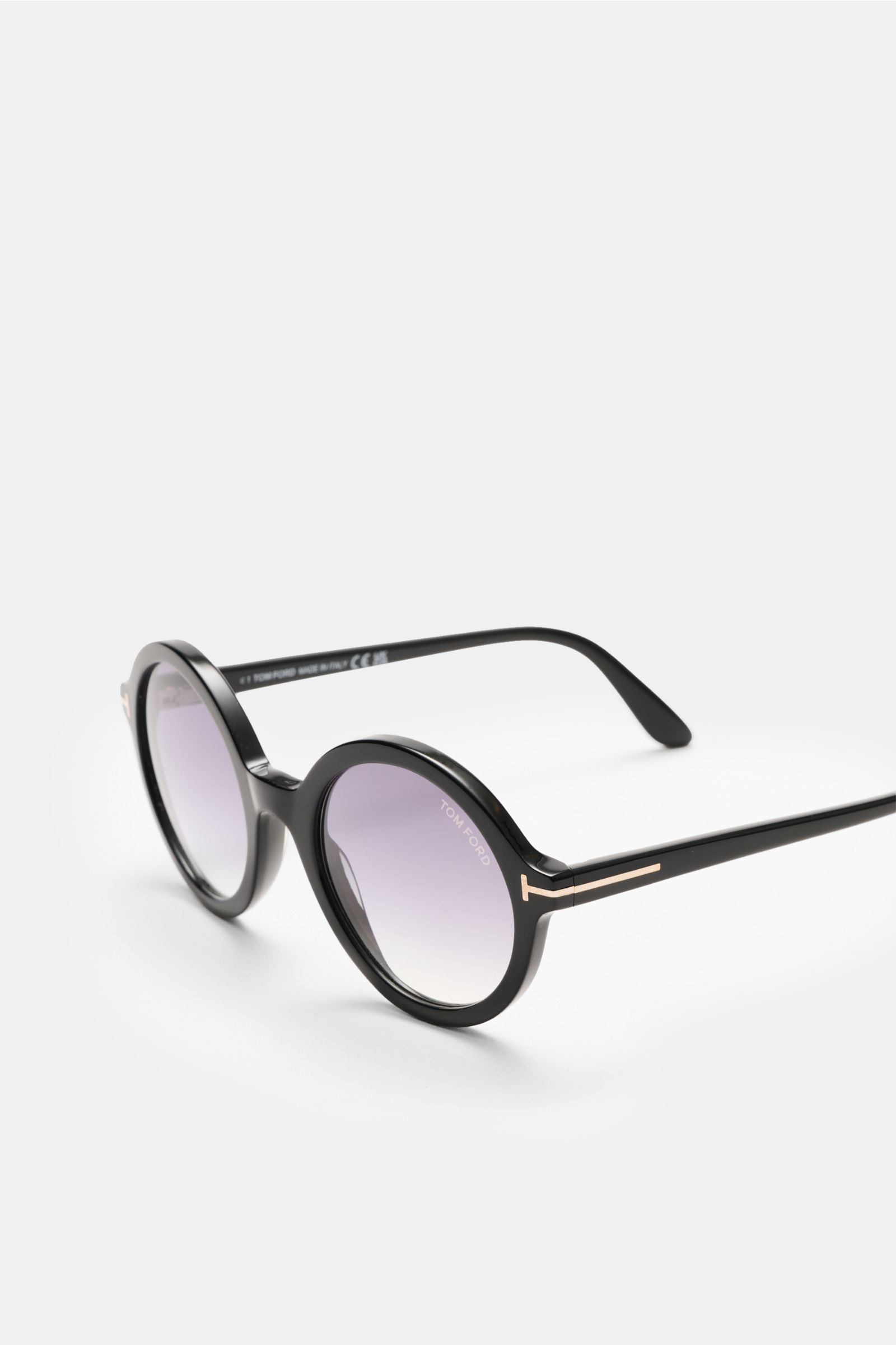 Tom Ford Sunglasses 'Nicolet' black/grey shown from a front-side angle, featuring round tinted lenses, thick acetate tortoiseshell frame, signature ‘T’ detail, 100% UV protection, filter category 3, and includes a velvet case.  
The 'Nicolette' sunglas