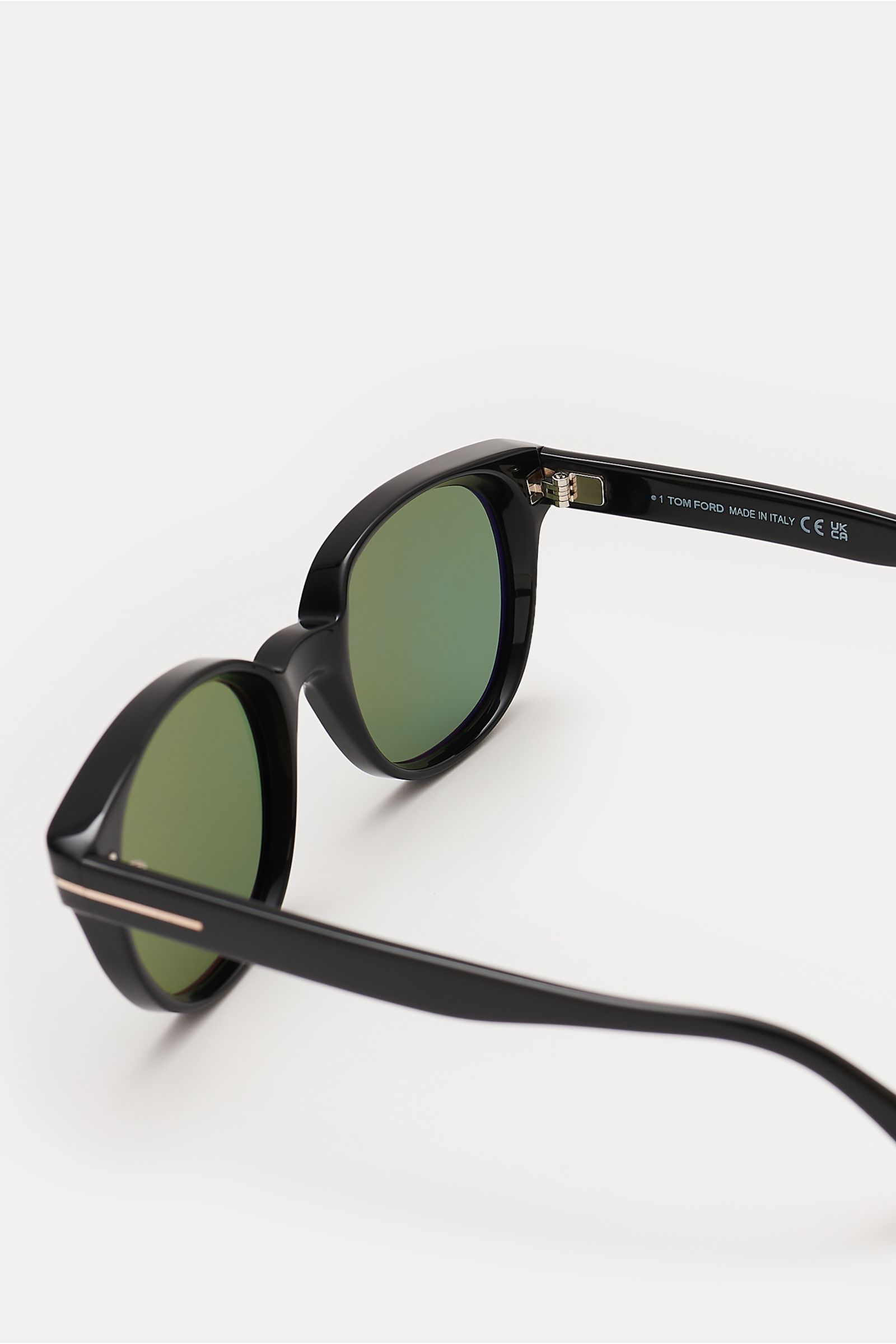 Tom Ford Sonnenbrille 'Mert' schwarz, Acetat-Rahmen, melierte Optik, leicht gerundete Silhouette, grüne Kunststoffgläser, UV-Schutz, seitliche Nahaufnahme.