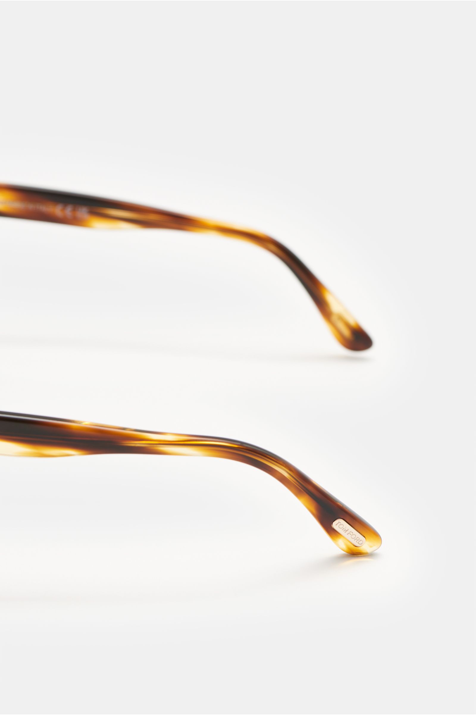 Tom Ford Sunglasses 'Mert' dark brown melange shown from side close-up, acetate frame, slightly rounded silhouette, mottled look.