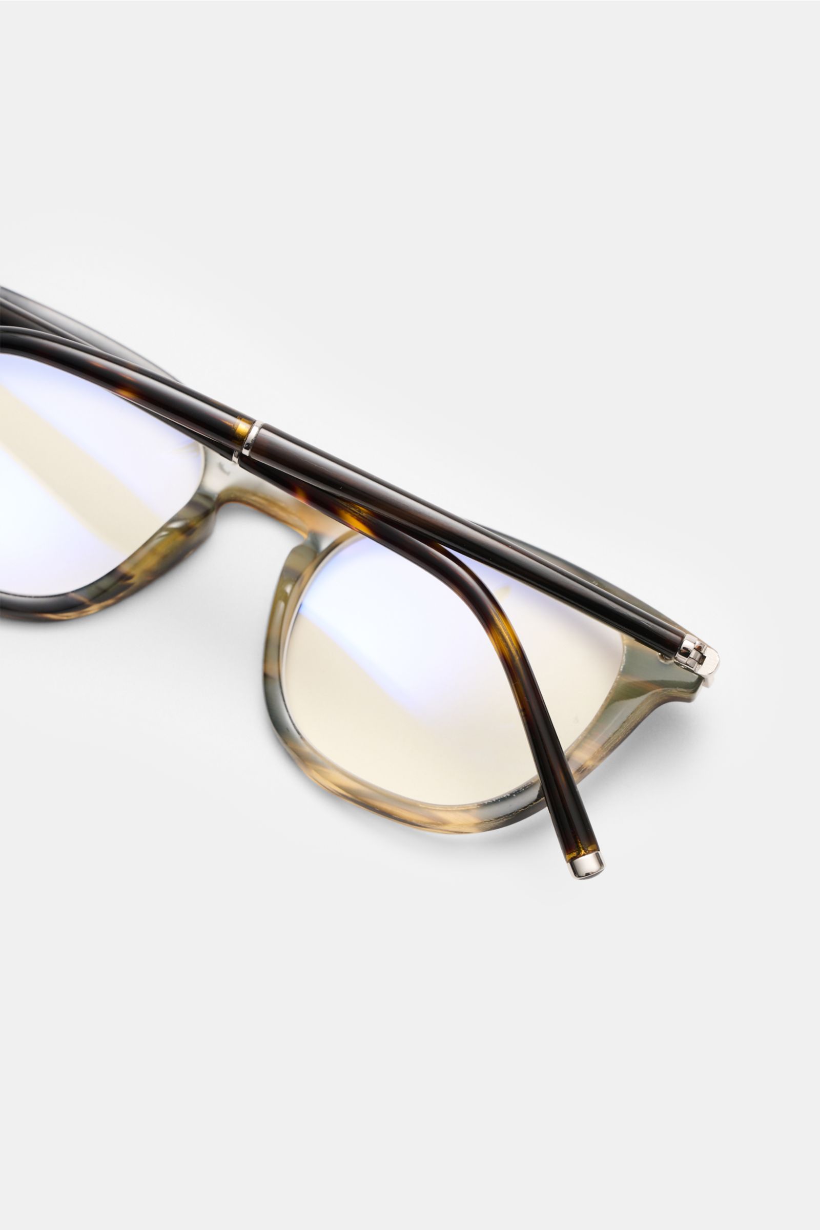 Close-up top view of Tom Ford Horn Brille 'Private Collection' schwarz/braun/sand gemustert with slightly rounded silhouette, buffalo horn frame, blue light filter lenses, and T-shaped details. Stilvoller Eyecatcher: Die exklusive Horn Brille aus der 'Pri