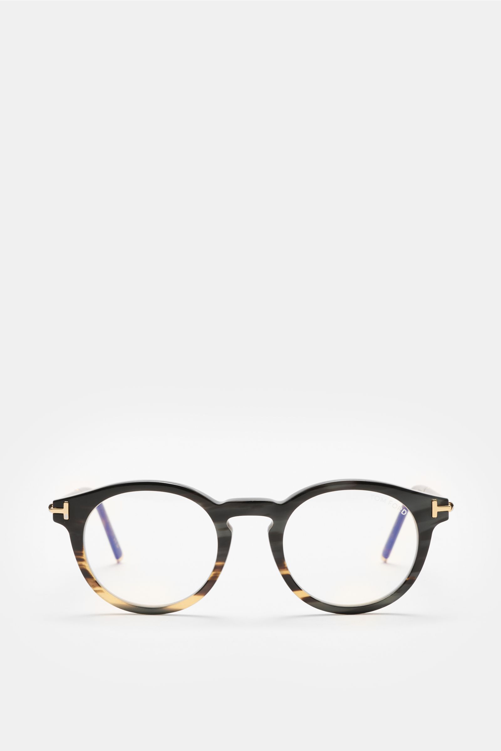 Front view of the Tom Ford Horn Brille 'Private Collection' schwarz/grau gemustert, a stylish round horn frame with blue light filter lenses and T-shaped gold details.  
Stilvoller Eyecatcher: Die exklusive Horn Brille aus der 'Private Collection' von 