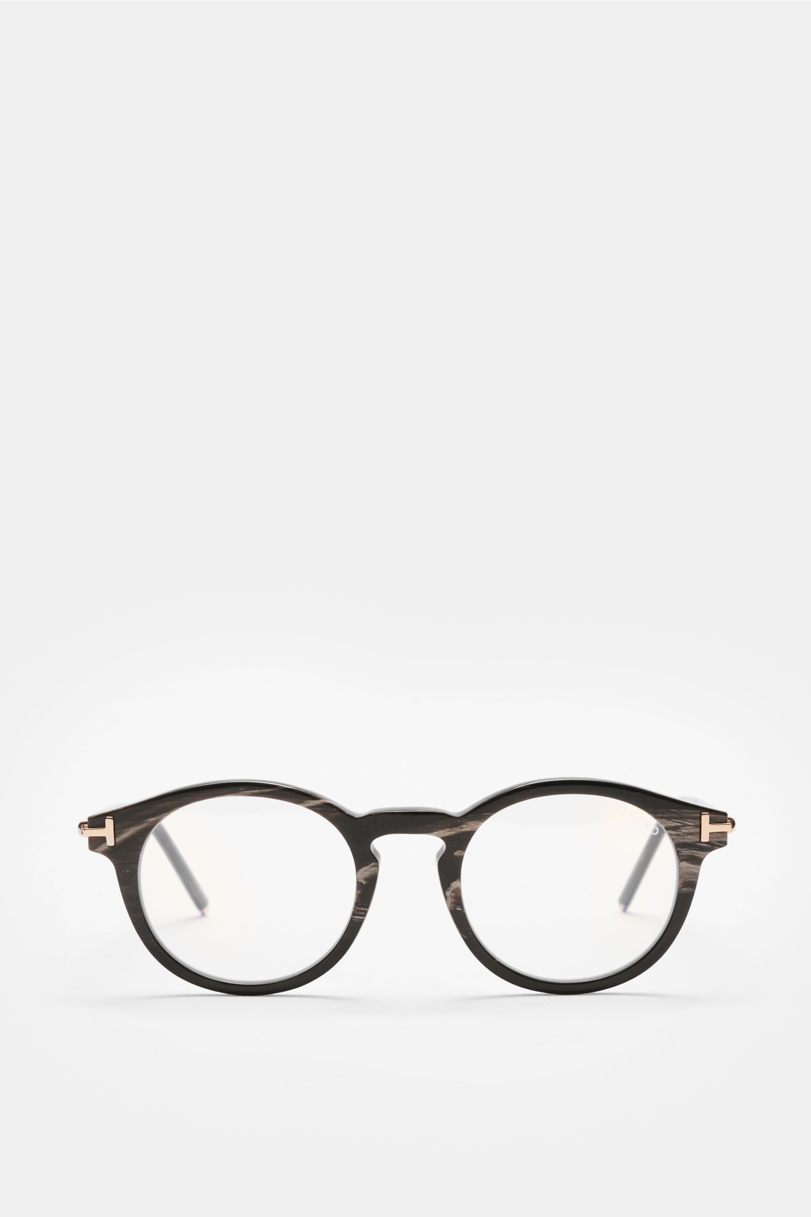 Tom Ford Horn Brille 'Private Collection' schwarz/graubraun/weiß gemustert, front view of round horn frame glasses with blue light filter lenses, T-shaped details, includes leather case, horn polish set, and cleaning cloth. Stilvoller Eyecatcher: Die exkl