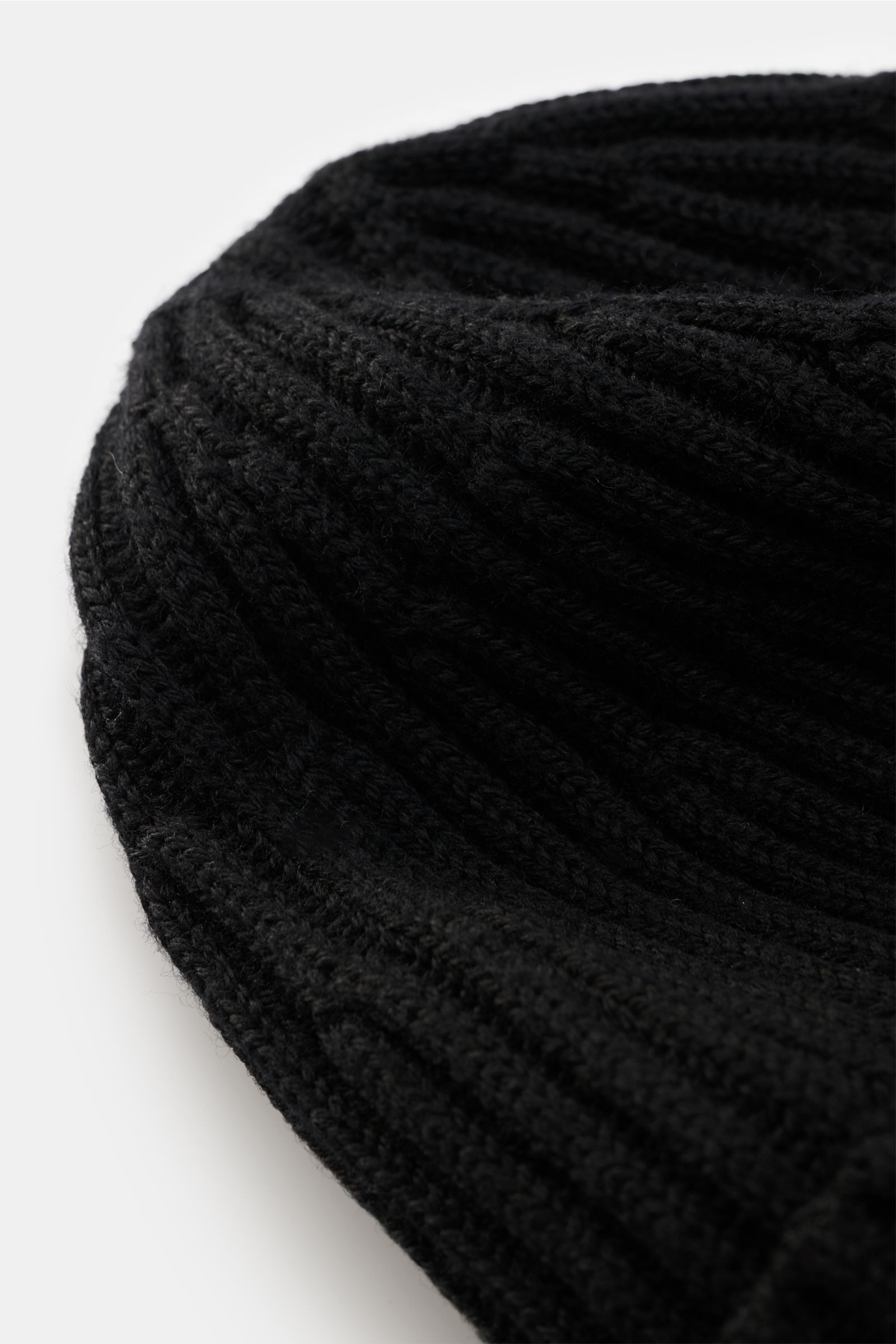 Close-up side view of a Stone Island Wool beanie black, featuring pure wool, soft feel, modern rib knit look, wide turn-up, and front with STONE ISLAND woven label.