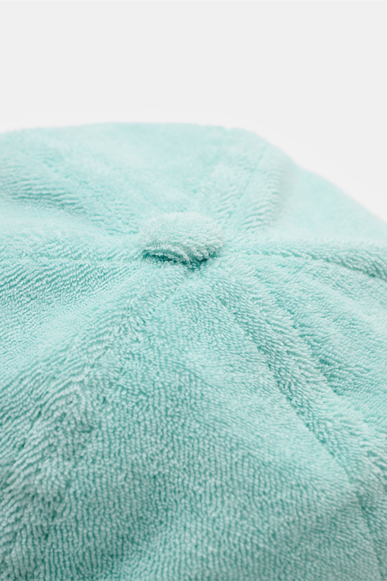 04651/ A trip in a bag Frottee-Cap 'Oyster' mintgrün in Nahaufnahme von oben, weiche Baumwollfrottee-Qualität, verstellbarer Verschluss, dezentes Weblabel hinten.