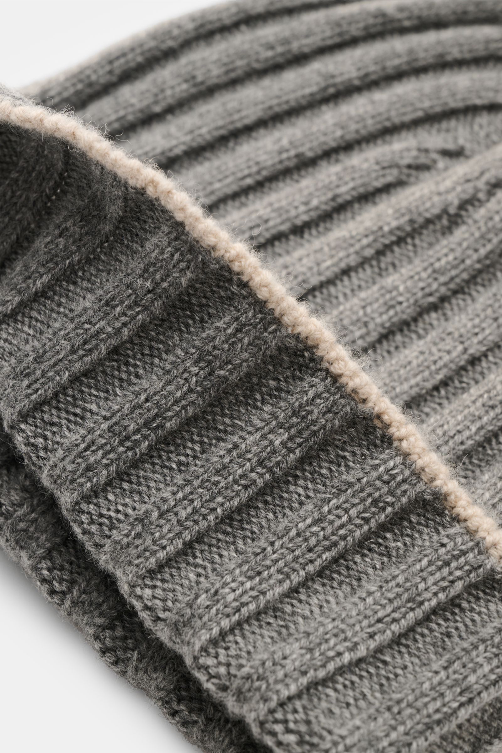 Close-up shot of the Brunello Cucinelli Cashmere Mütze grau meliert showing ribbed knit texture and contrasting edge detail.

Diese Mütze aus edlem Cashmere im zeitlosen Rippstrick-Design von BRUNELLO CUCINELLI bringt behagliche Wärme und luxuriösen Ko