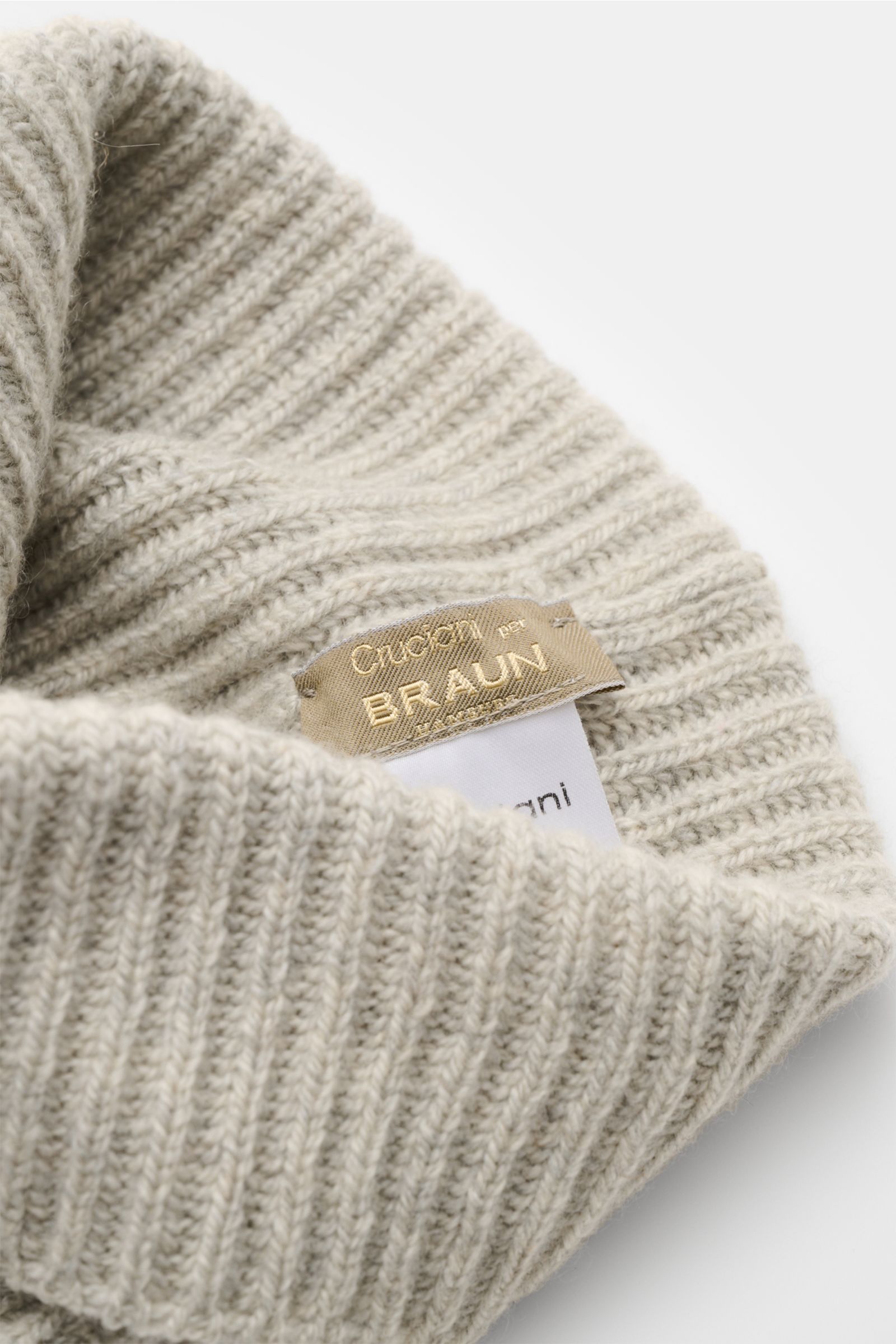 Close-up side view of Cruciani Cashmere beanie light grey showing brioche stitch pattern, small turn-up, and brand label inside. For cosy winter moments with style: This brioche stitch beanie in pure cashmere with a narrow turn-up by CRUCIANI keeps you sn