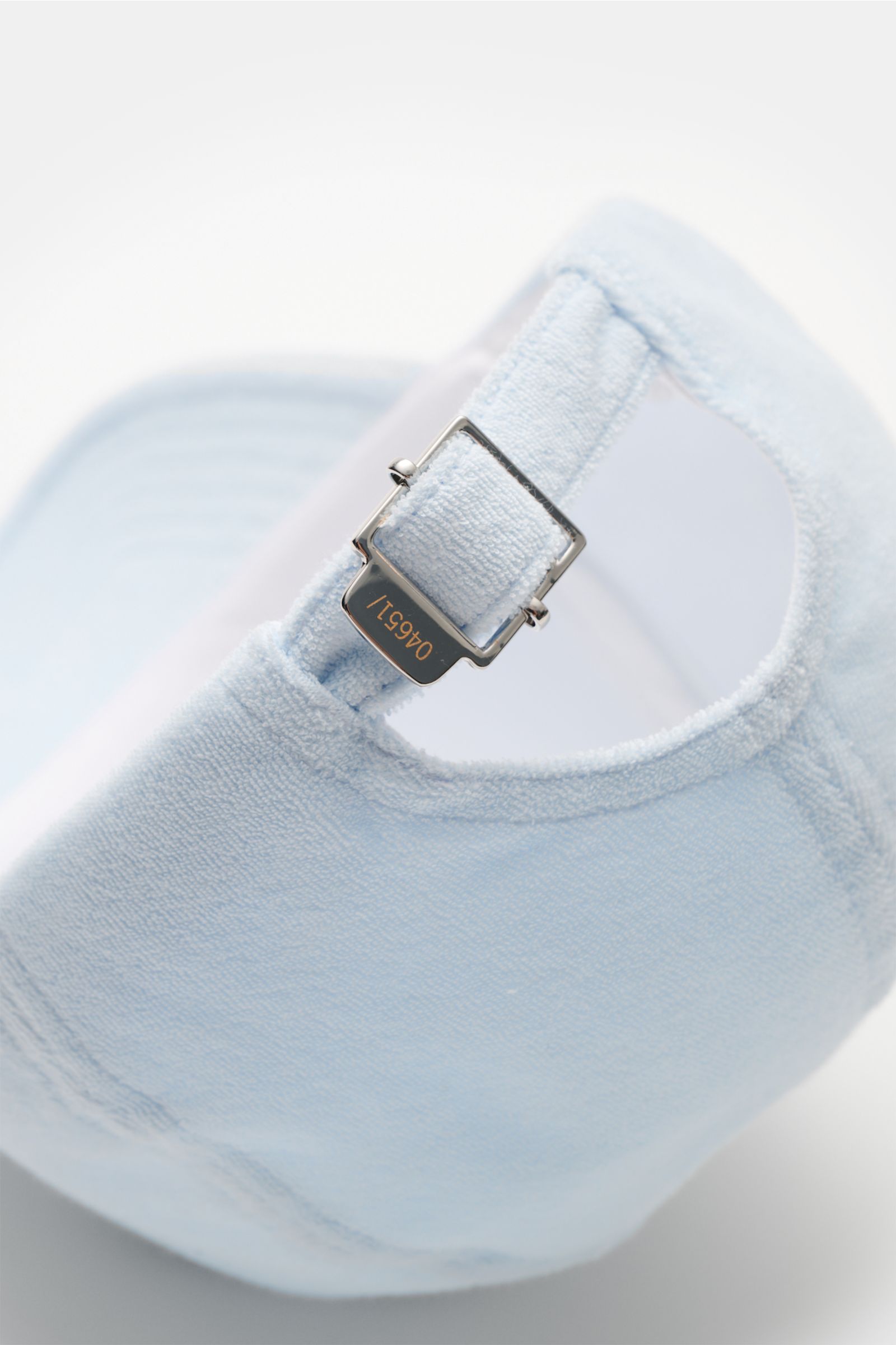 Close-up rear view of 04651/ A trip in a bag Terry baseball cap 'Terry' pastel blue in soft cotton terry with adjustable metal buckle.

Description: Spring awakening: This stylish baseball cap in soft terry by label 04651/ A TRIP IN A BAG offers good p