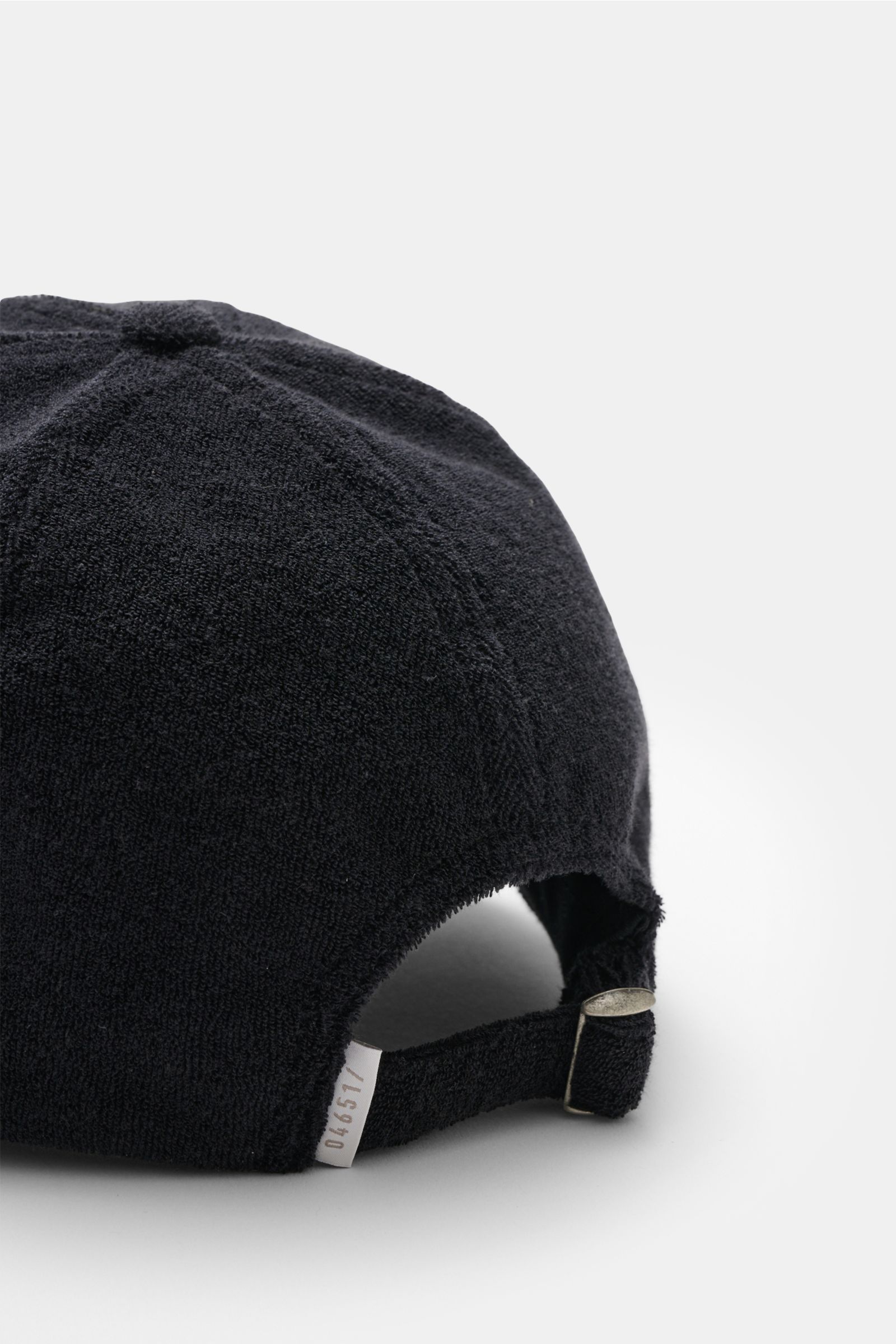 Black 04651/ A trip in a bag Terry baseball cap 'Terry' in soft cotton terry, six-panel style with adjustable closure, shown from rear side. Spring awakening: This stylish baseball cap in soft terry from the label 04651/ A TRIP IN A BAG offers good protec