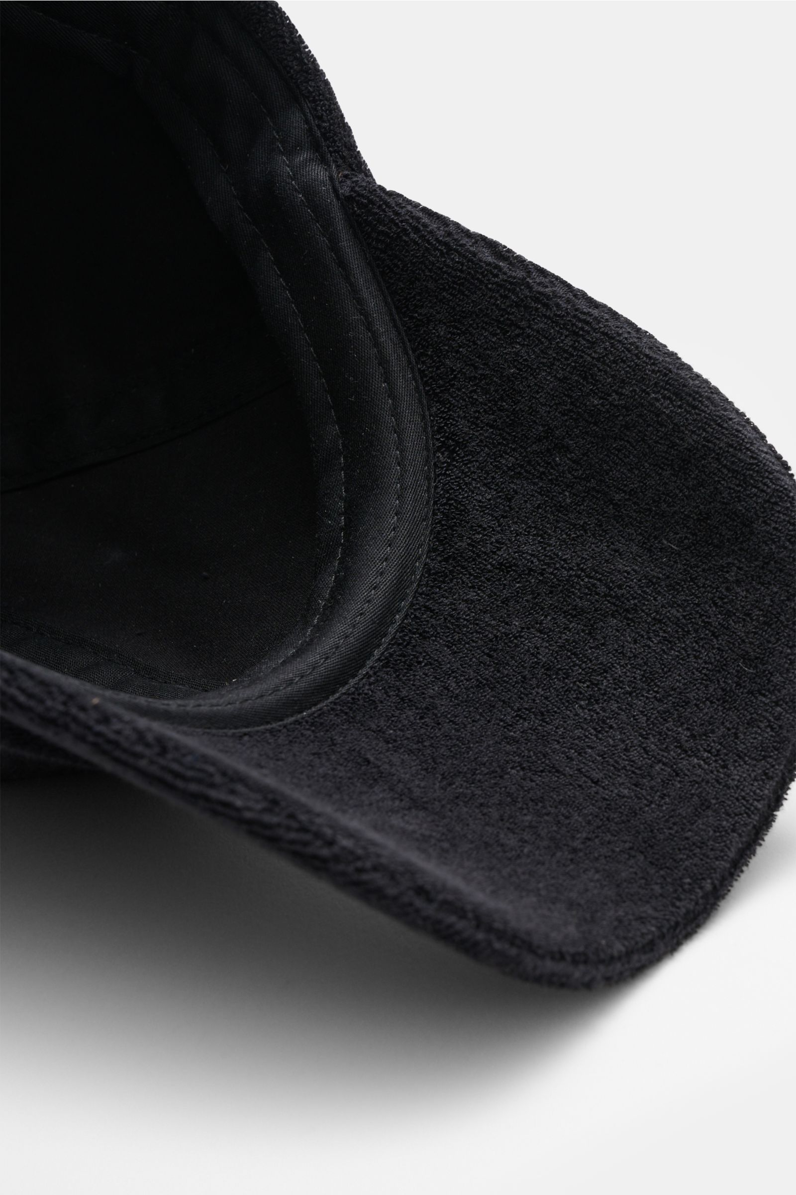 Close-up view from above inside the brim of the 04651/ A trip in a bag Terry baseball cap 'Terry' black in soft cotton terry material.

Spring awakening: This stylish baseball cap in soft terry from the label 04651/ A TRIP IN A BAG offers good protecti