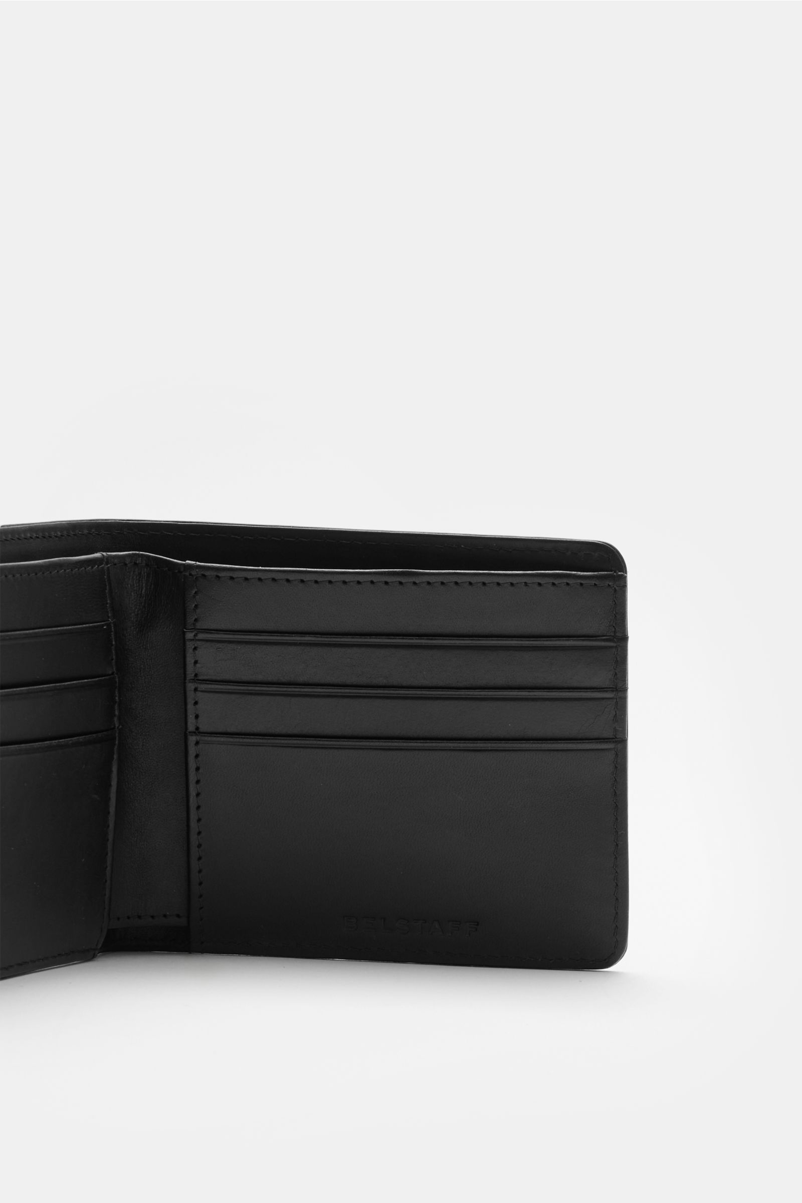 Open black Belstaff Portemonnaie schwarz wallet photographed from the front showing smooth cowhide leather, eight card slots, one banknote compartment, and tonal logo embossing.