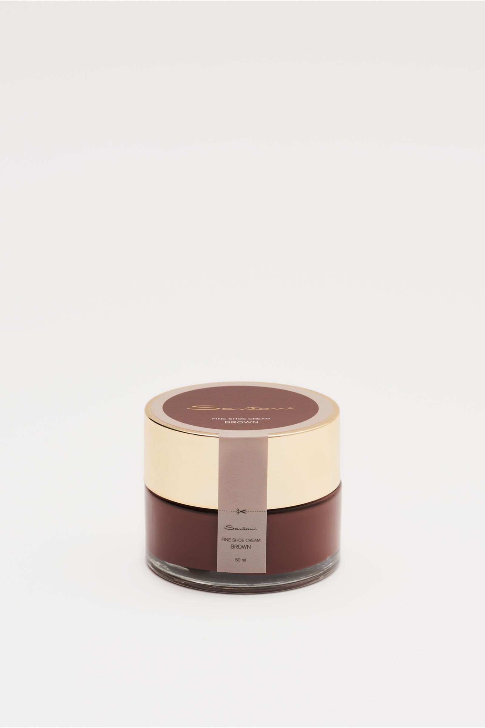 Santoni Schuhcreme braun 50 ml shown from a slightly elevated front view, in a brown glass jar with a gold lid and label. Unverzichtbares Utensil für die handgearbeiteten Meisterwerke von SANTONI: Perfekt auf den Schuh abgestimmt, bewirken die Inhaltss