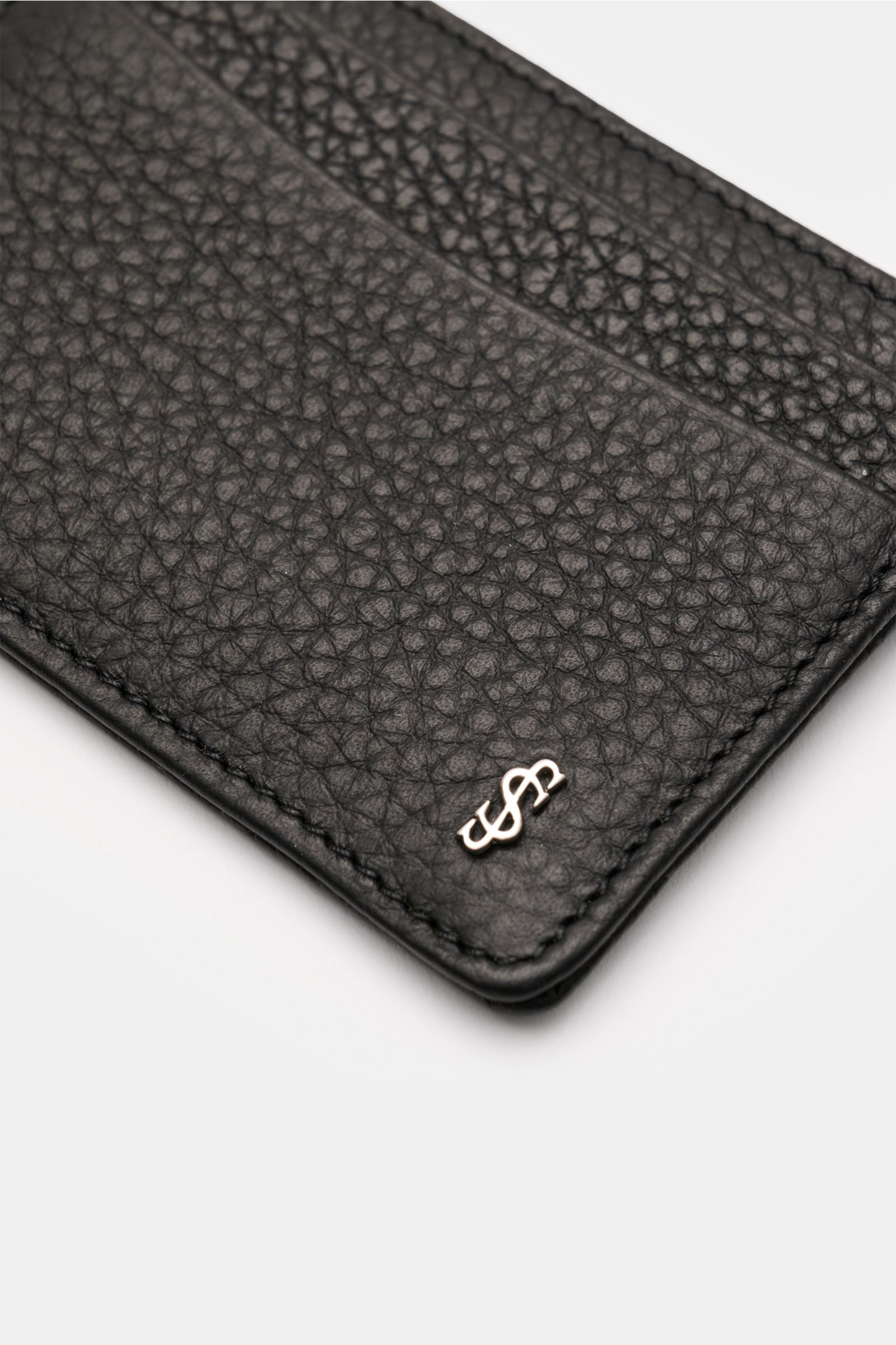 Serapian Kartenetui schwarz aus edlem Cashmere-Kalbleder mit markanter Narbung, silberfarbenem Metall-Logo, vier Kartenfächern, Hauptfach, ca. 10x7 cm, Detailfoto schräg von oben.