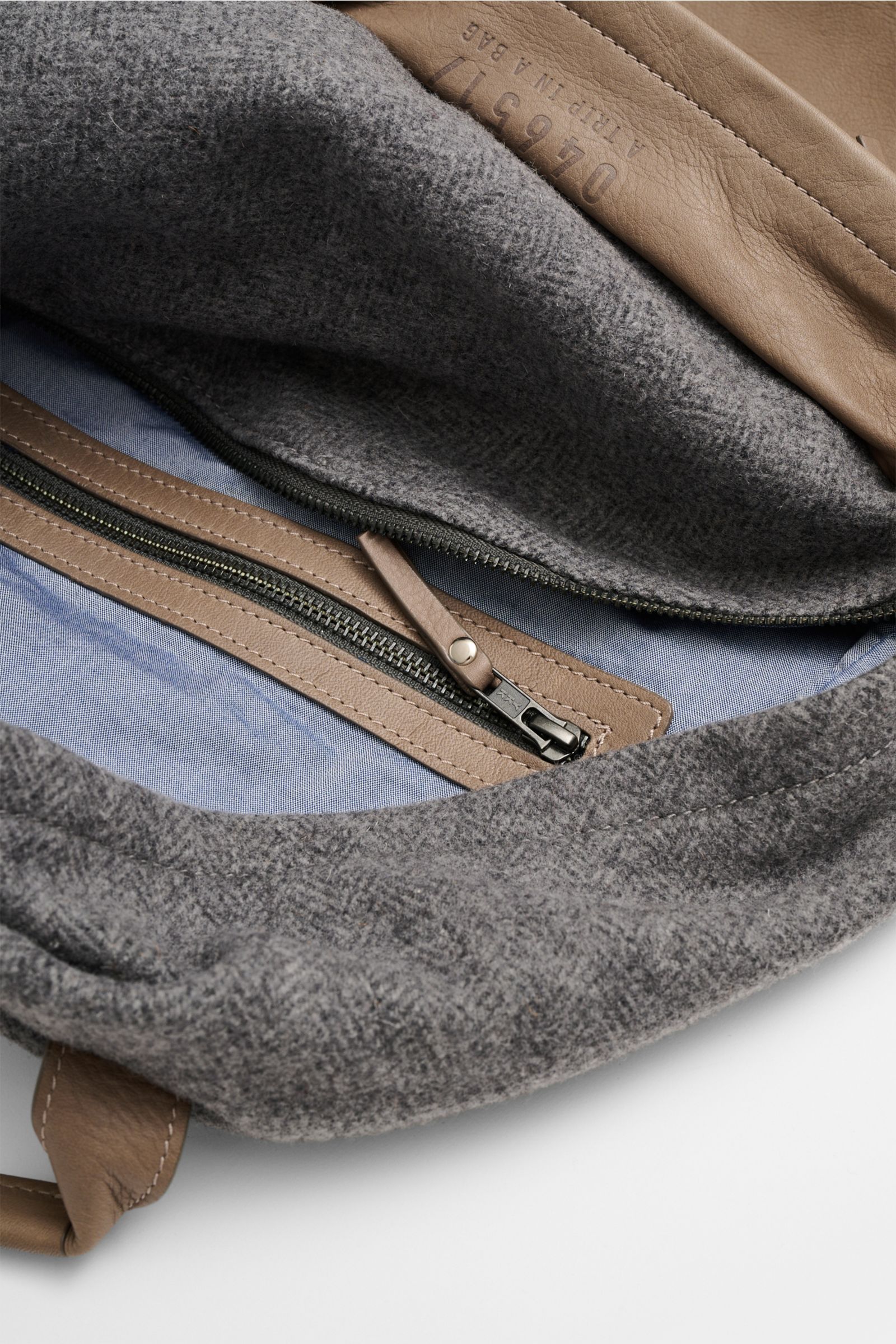 Innenansicht des 04651/ A trip in a bag Rucksack 'Herringbone' grau meliert/taupe mit Fischgratmuster, Nappaleder, Reißverschlussfach und Textilfutter.