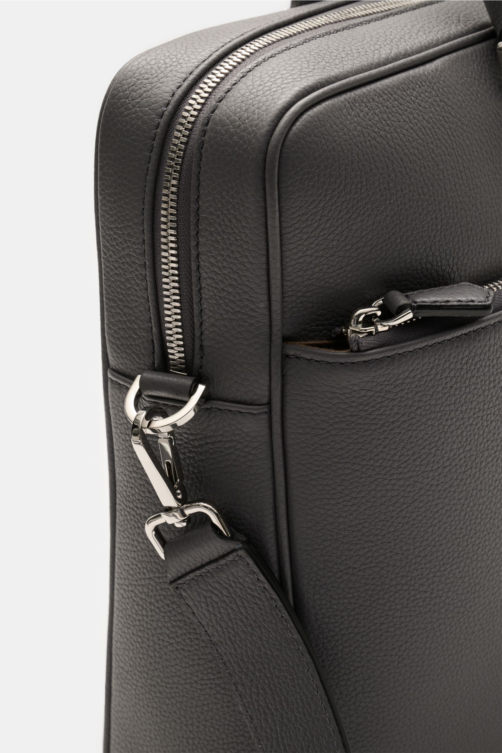 Close-up side view of the Serapian Aktentasche grau, showcasing its markant genarbtes Kalbleder, silver hardware, zipper, and robust detachable shoulder strap.
