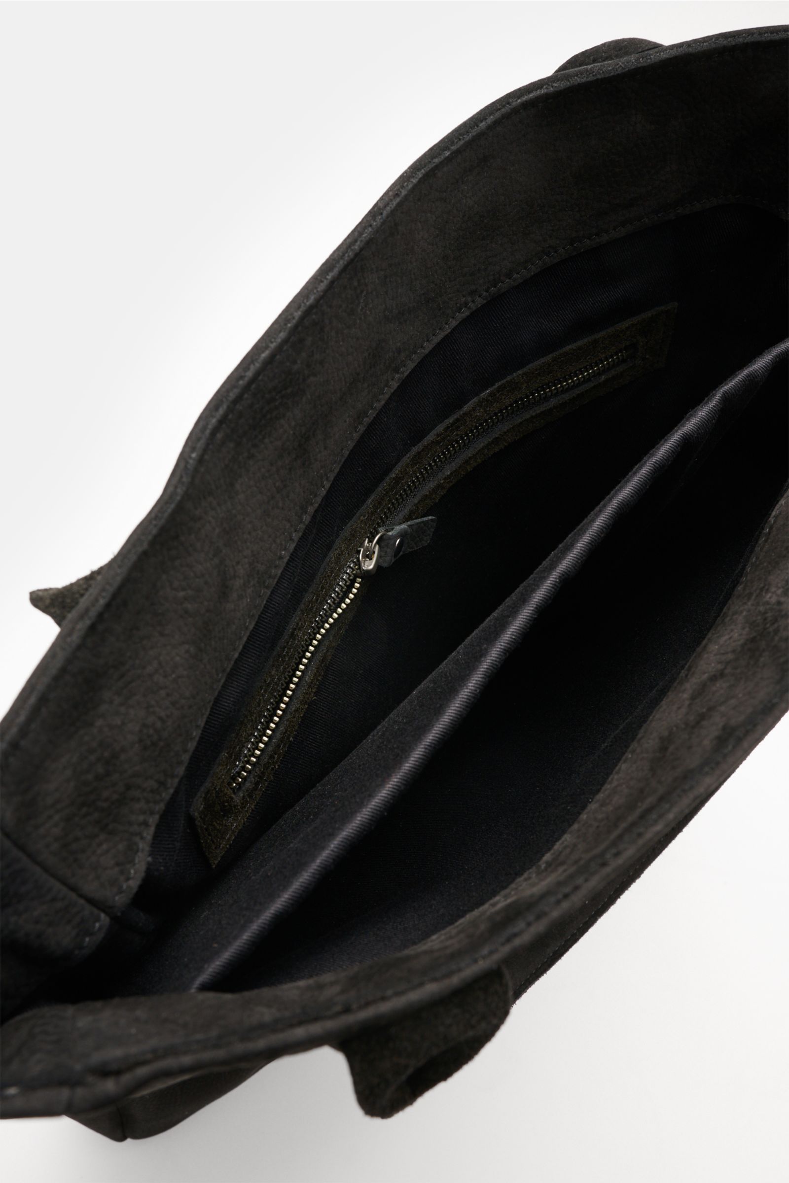 Interior close-up from above of the 04651/ A trip in a bag Tote-Bag schwarz showing spacious main compartment, zippered pocket, laptop pocket, and black fabric lining. Geräumiger Allrounder: Die Leder Tote-Bag des Labels 04651/ A TRIP IN A BAG bietet opti