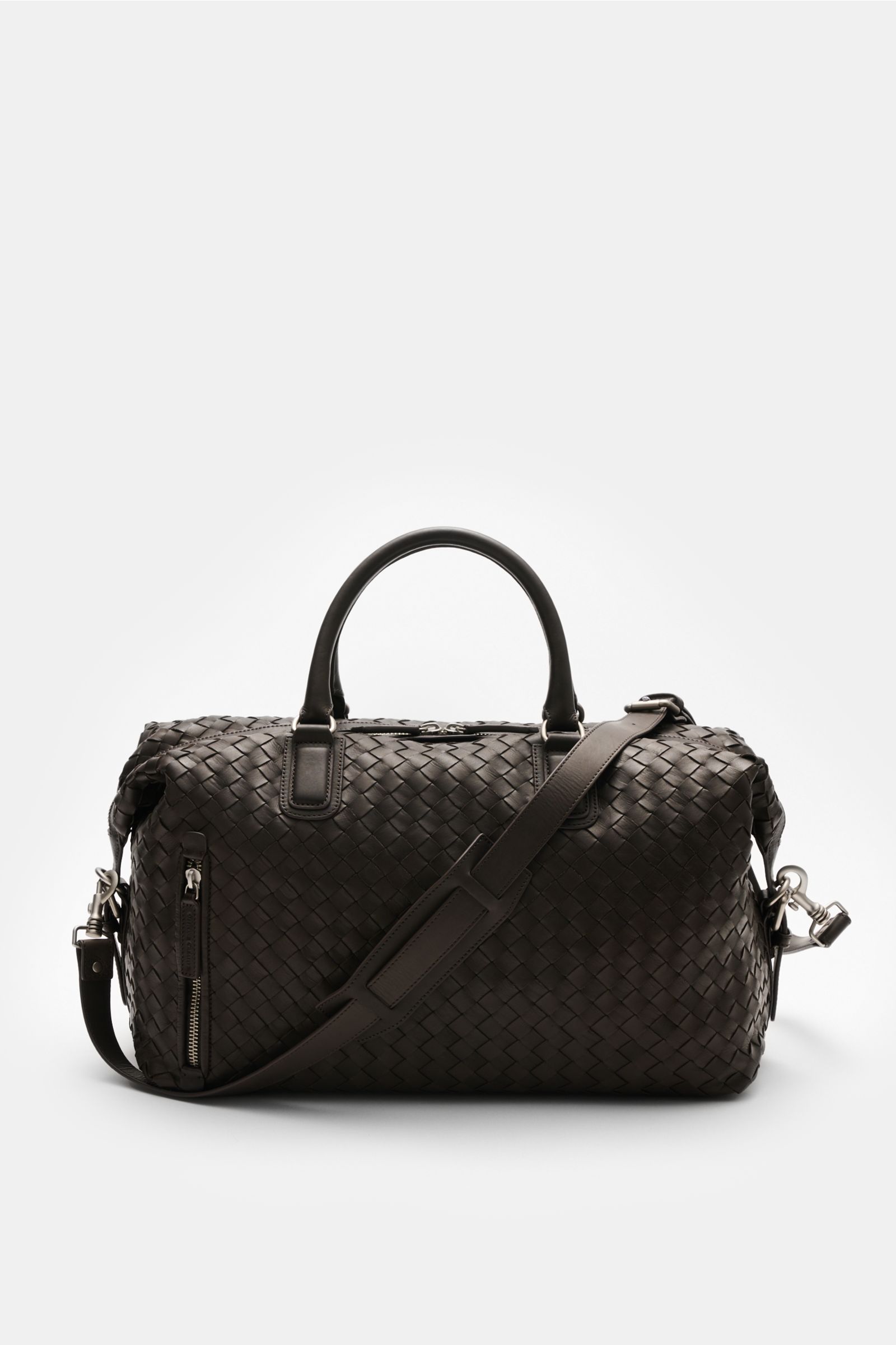 Officine Creative Weekender dunkelbraun, frontale Ansicht, fein genarbtes gewebtes Leder, matte silberne Hardware, verstellbarer Schultergurt.