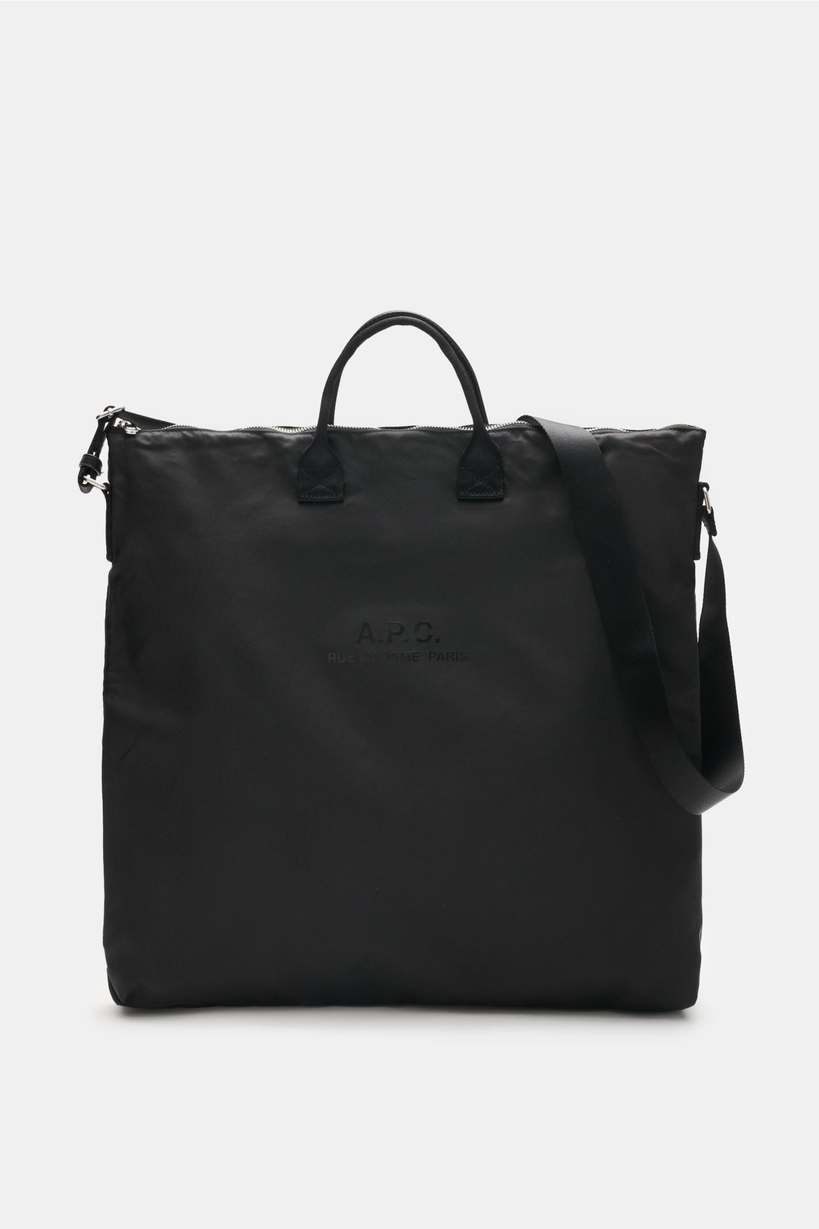 A front view of the A.P.C. Tasche 'Crossbody Bag Backstage' schwarz, a versatile everyday companion made of high-quality black microfiber with silver hardware, durable textile straps, a practical shoulder strap, logo print on the front, spacious main comp