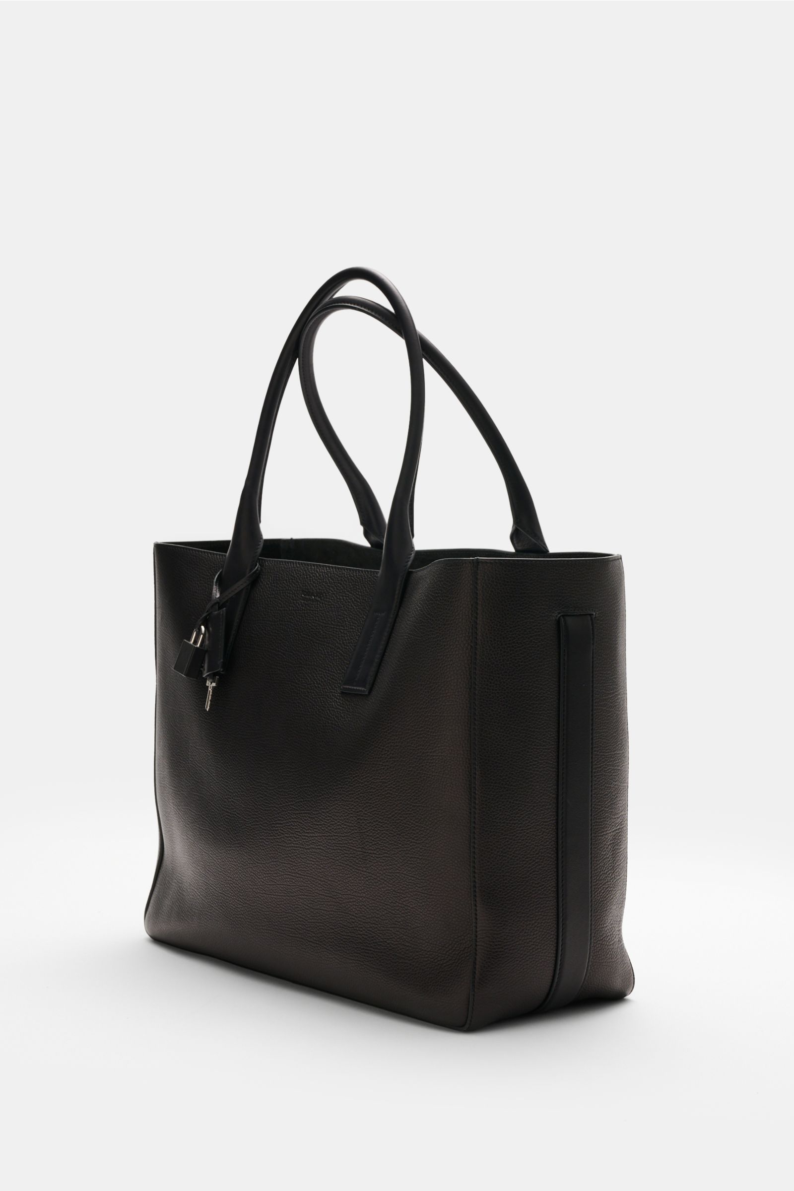 Side-front view of Tom Ford Shopper schwarz in finely grained black calf leather with smooth leather details, silver hardware, and key-lock charm.