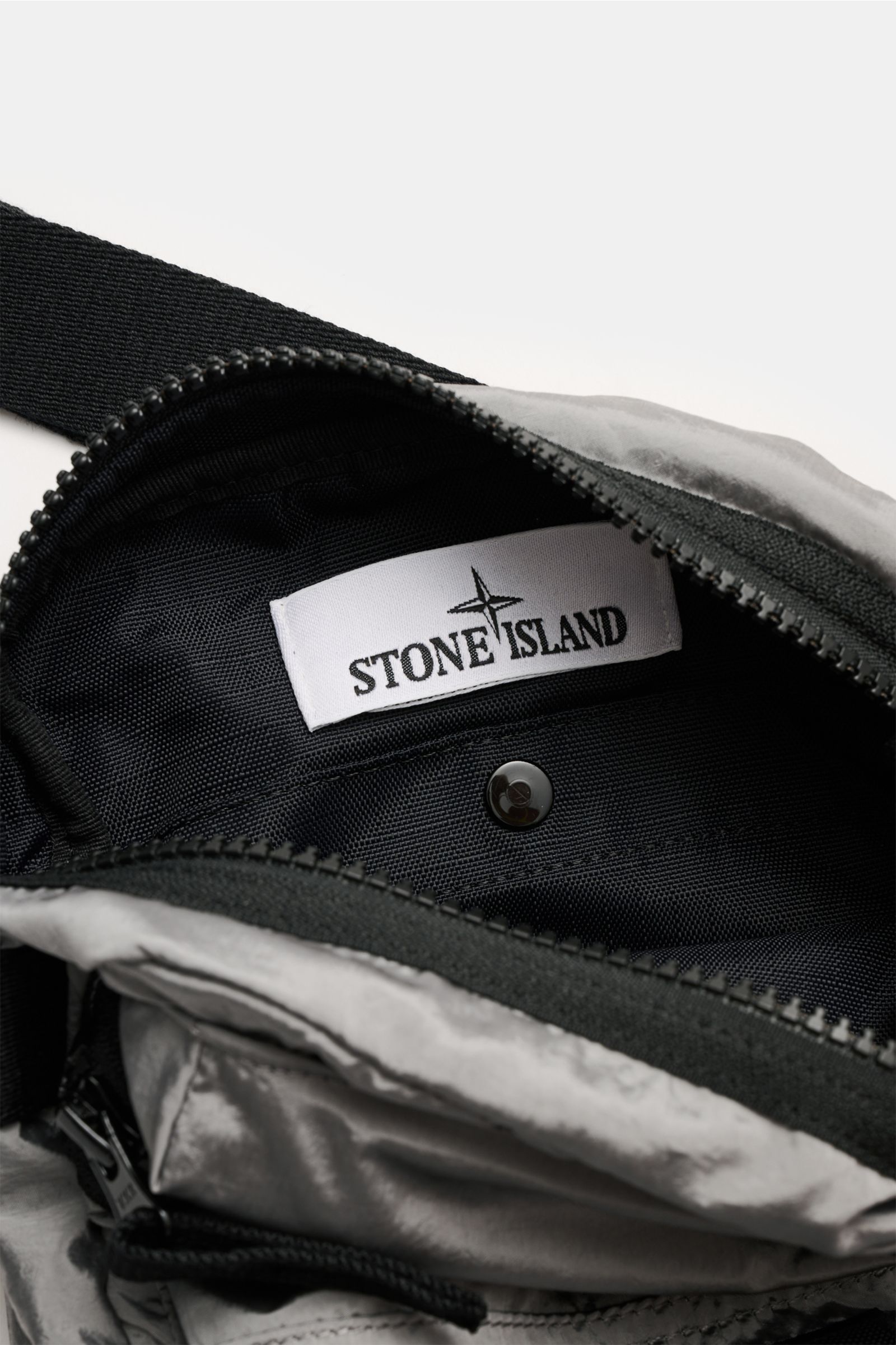 Stone Island Crossbody Bag 'Marsupio Tracolla' grau, Innenansicht mit offenem Reißverschluss und sichtbarem Logo, robust und kompakt.