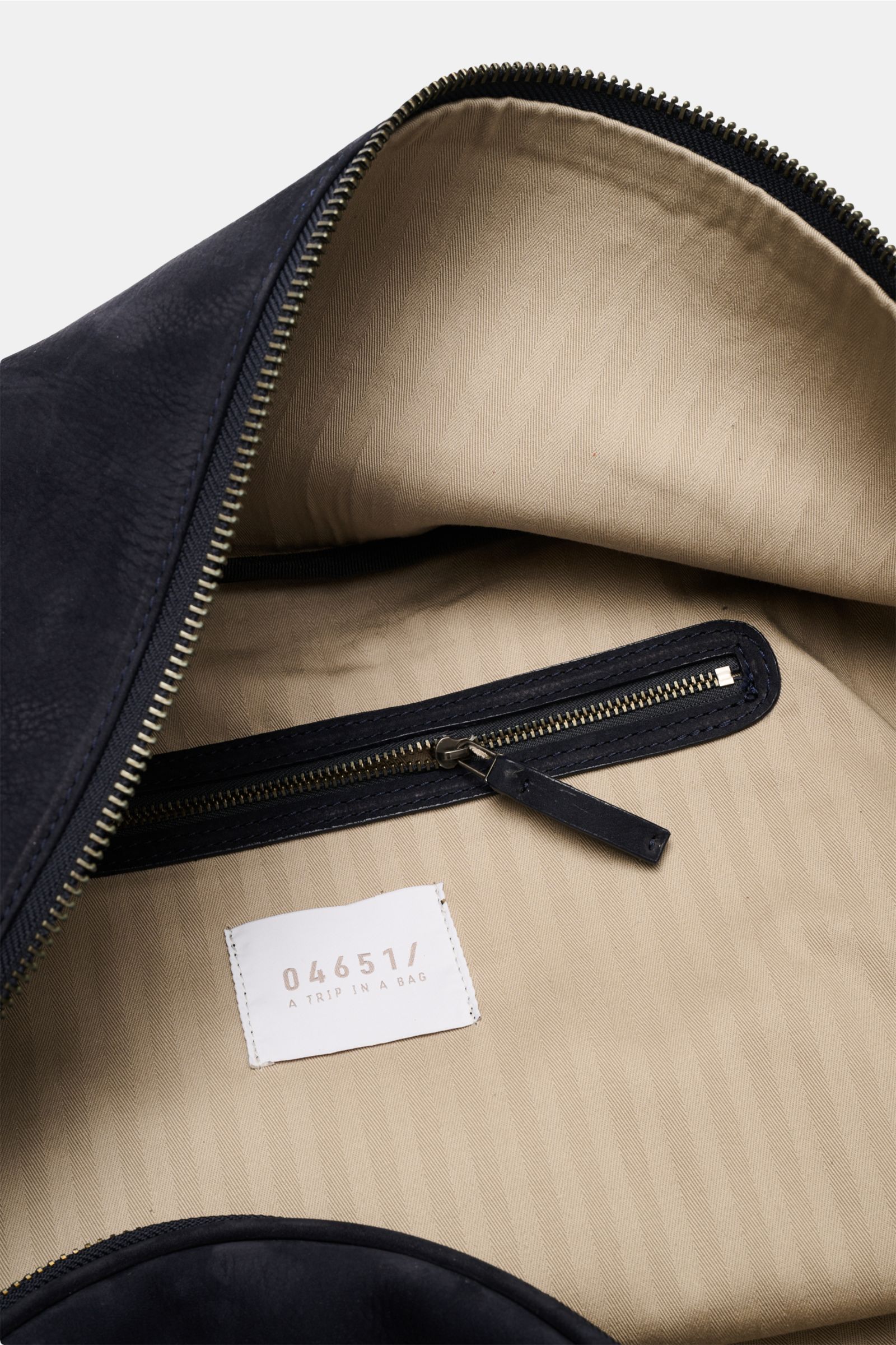 Close-up inside view of the 04651/ A trip in a bag Weekender '356 Bag' navy showing beige textile lining, internal zipper pocket, and smooth zipper from the top perspective.