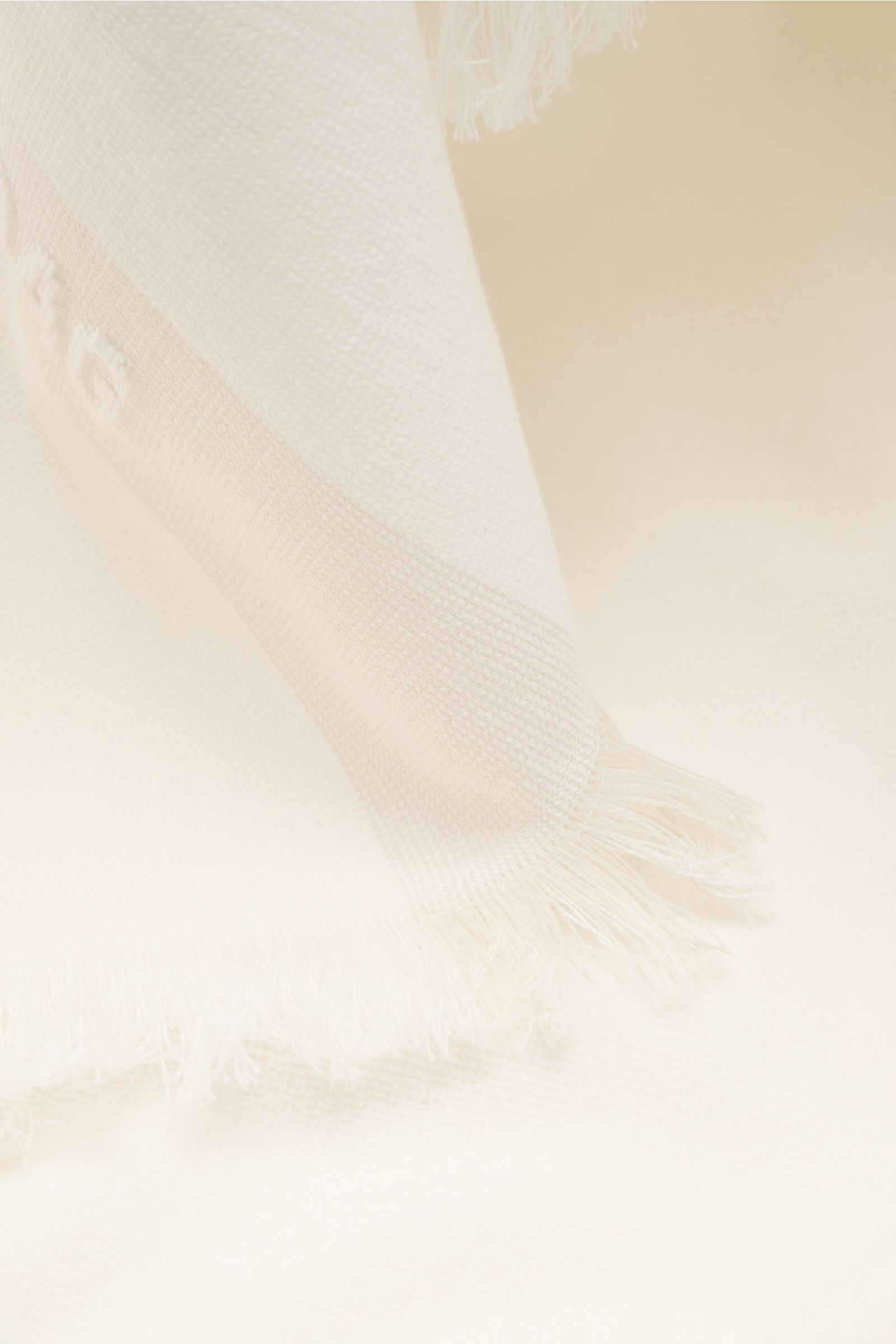 Offwhite 04651/ A trip in a bag Strandtuch photographed close-up from the side, showing soft cotton terry fabric and narrow fringed edge.